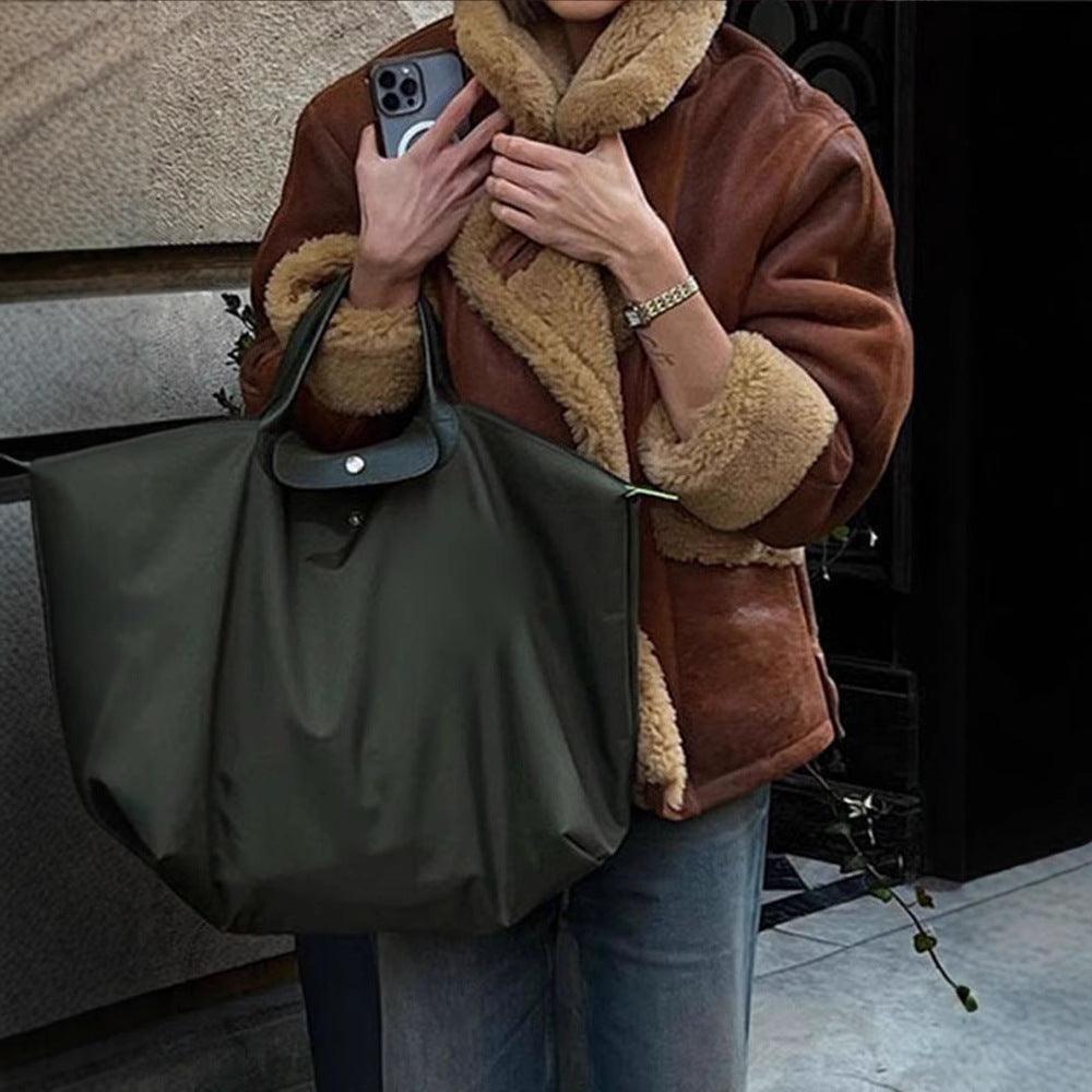 Woman wearing Cozy Cowgirl Lamb's Wool Casual Jacket – Stylish & Comfortable for Cowgirls, with large black tote bag.