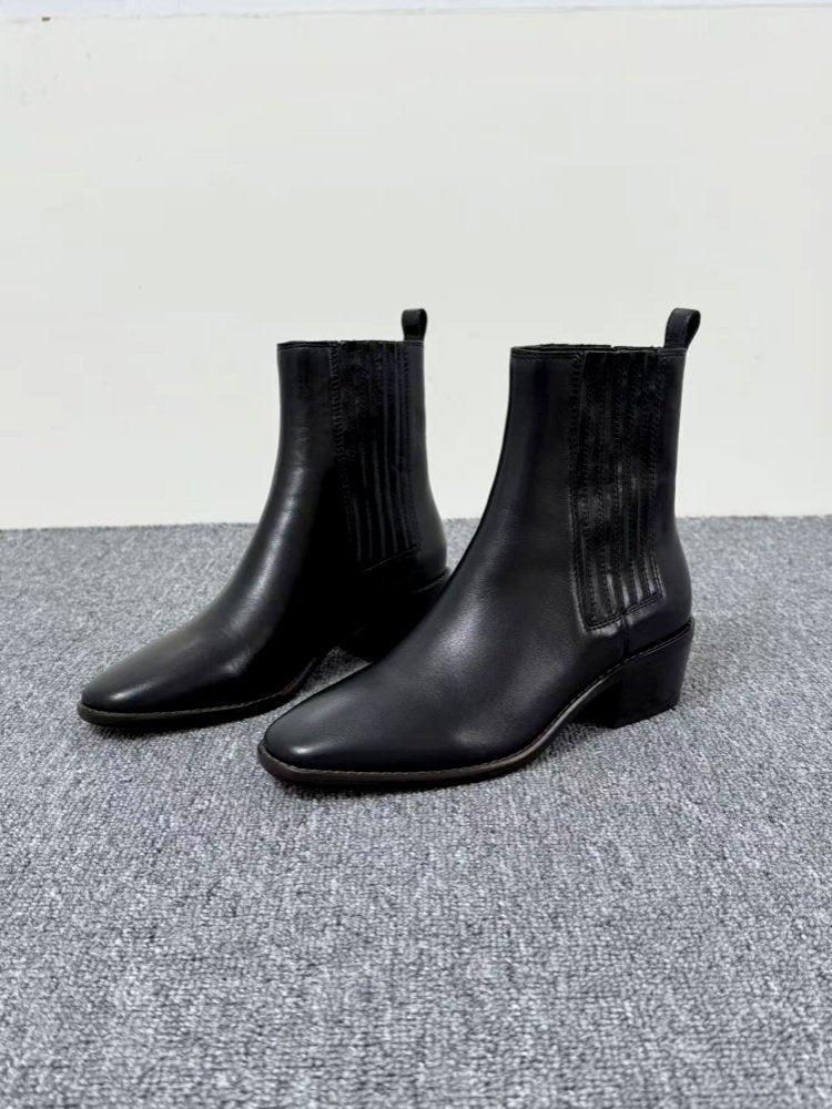 Women’s Retro Square-Toe Mid-Heel Chunky Leather Boots in black, showcasing classic and modern style on a gray carpet.
