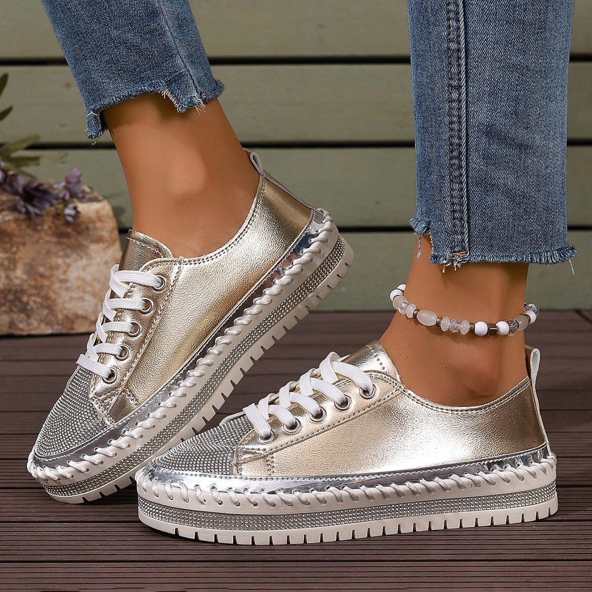 Shiny metallic sneakers with textured sole and casual denim jeans