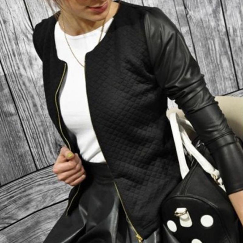 Stylish woman wearing a Women’s Plaid Patchwork Blazer with PU leather sleeves against wooden backdrop.