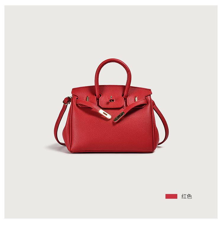 Red leather handbag with gold clasp and handles