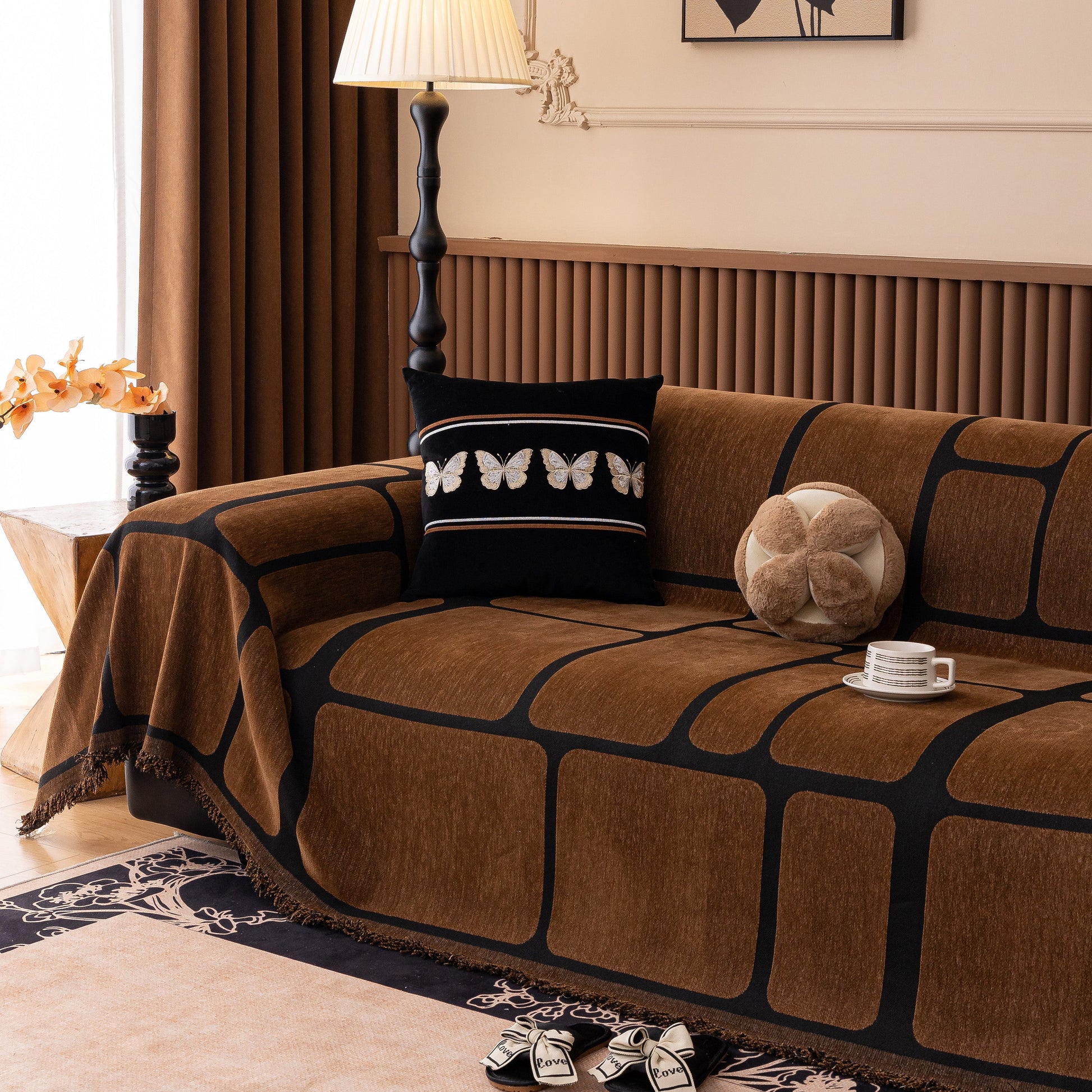 Brown Modern Geometric Sofa Cover Decorative Couch Throw Blanket Furniture Protector with tassel edges on a living room sofa.