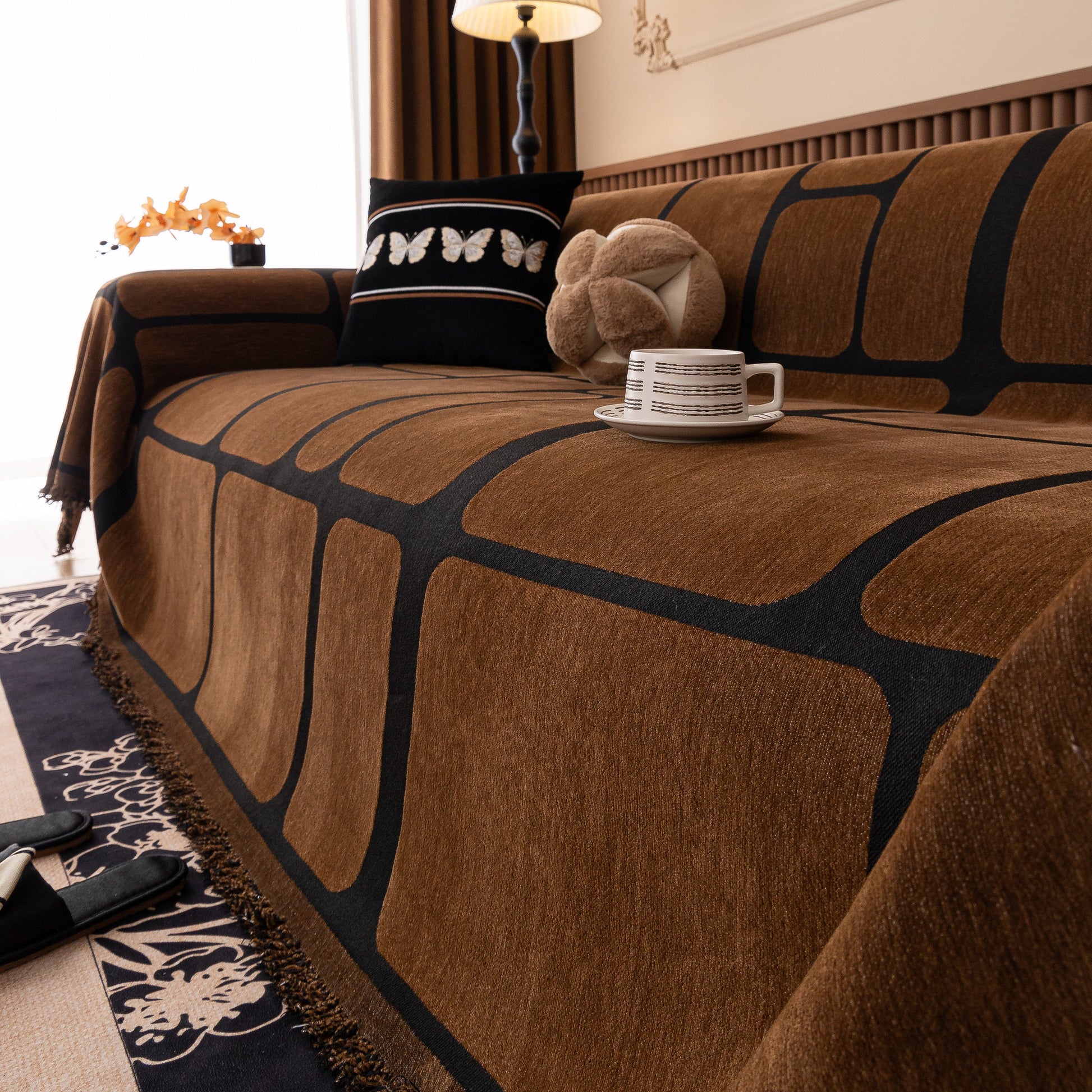 Modern Geometric Sofa Cover Decorative Couch Throw Blanket Furniture Protector with chenille fabric and tassel edges on a sofa.