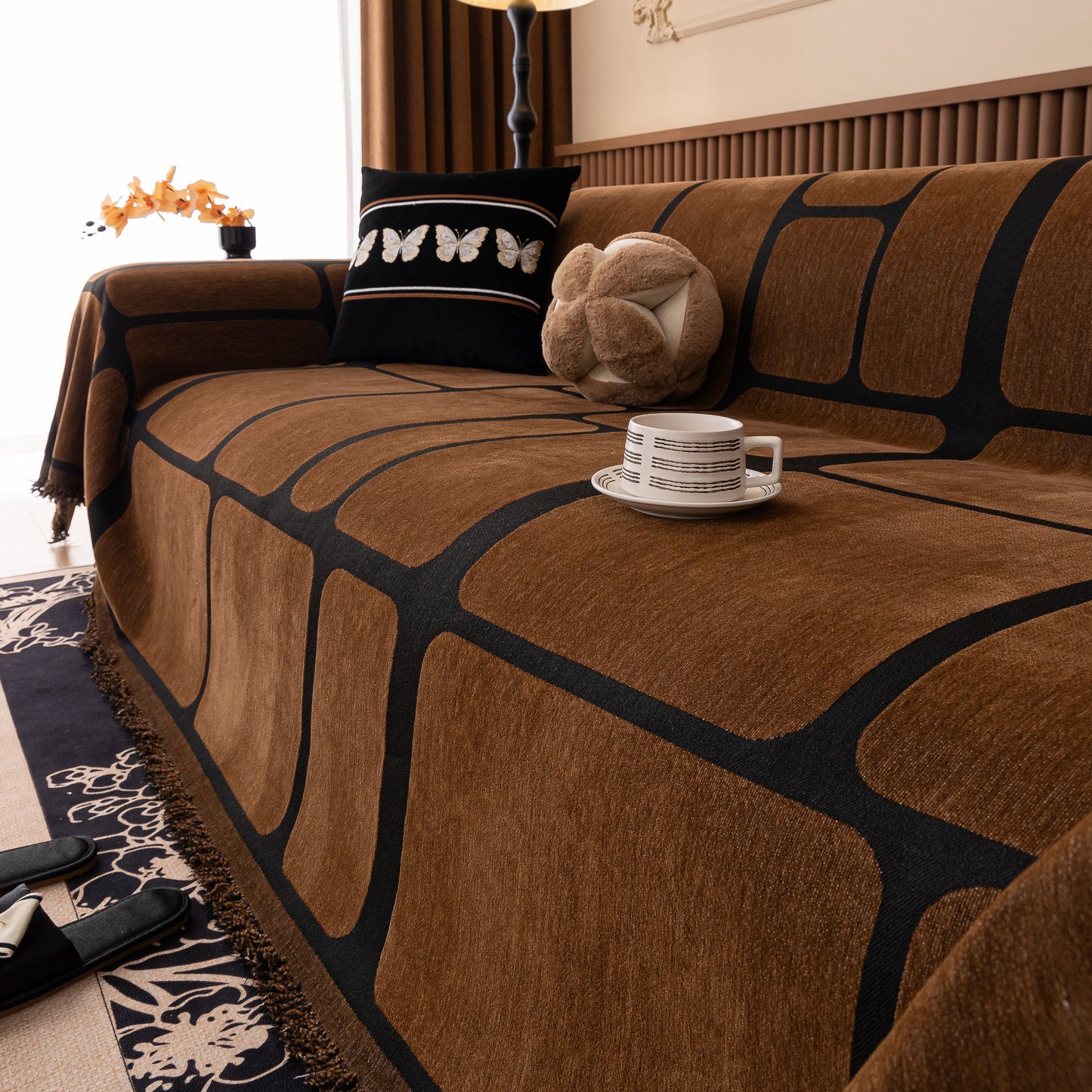 Modern Geometric Sofa Cover Decorative Couch Throw Blanket Furniture Protector on a brown couch with tassel edges.