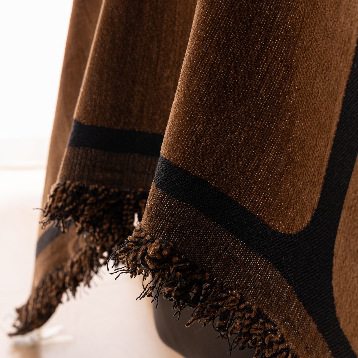 Close-up of Modern Geometric Sofa Cover Decorative Couch Throw Blanket Furniture Protector with fringe detail in chenille fabric.