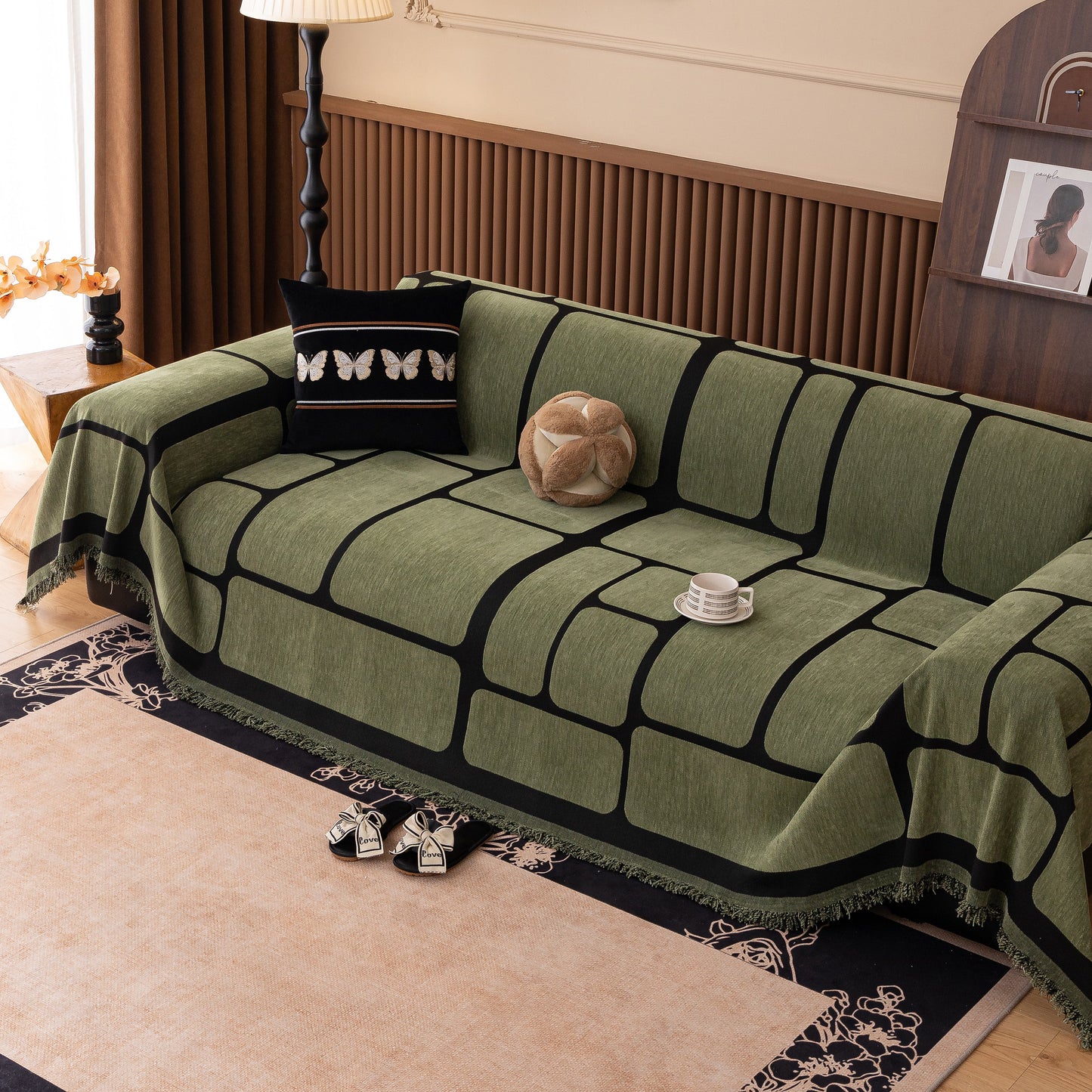 Living room with a modern geometric sofa cover decorative couch throw blanket furniture protector in green and black squares pattern.