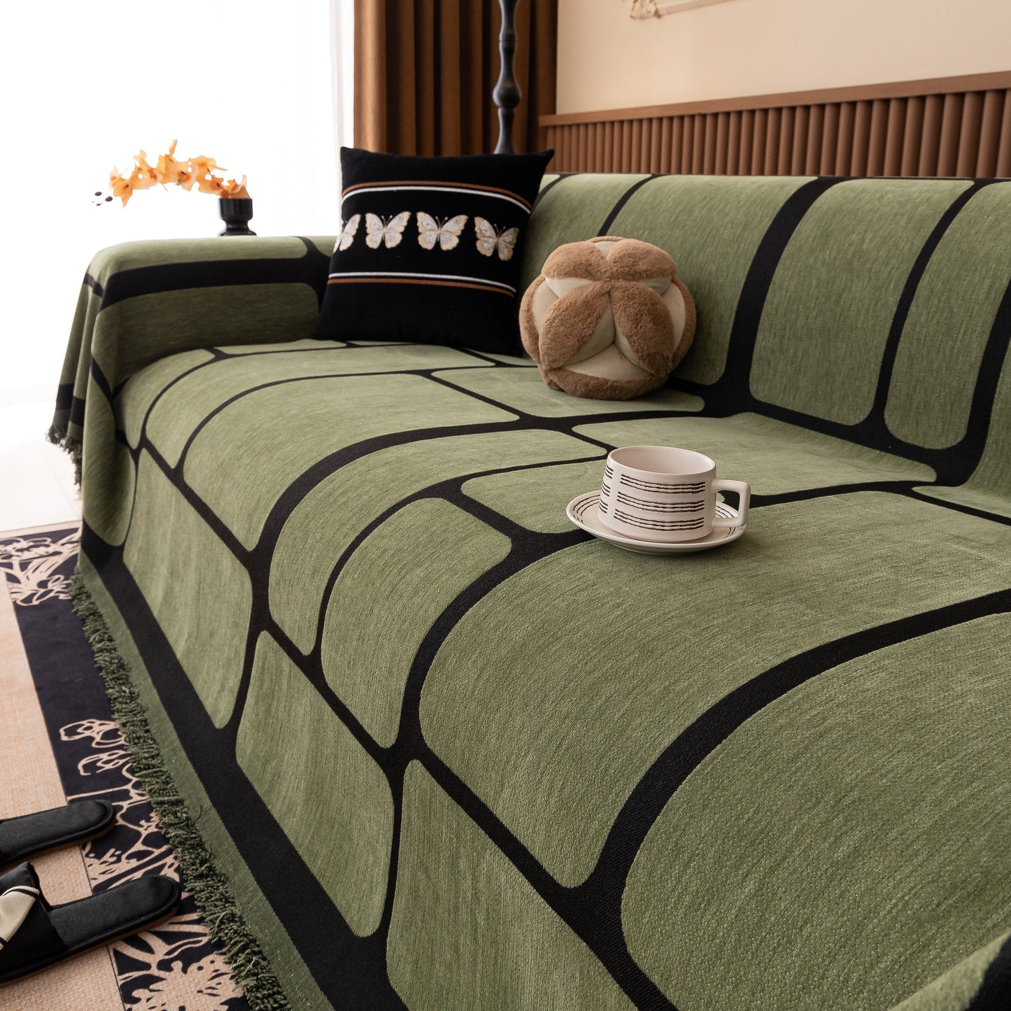 Modern Geometric Sofa Cover Decorative Couch Throw Blanket Furniture Protector in green with black geometric pattern and tassel edges.