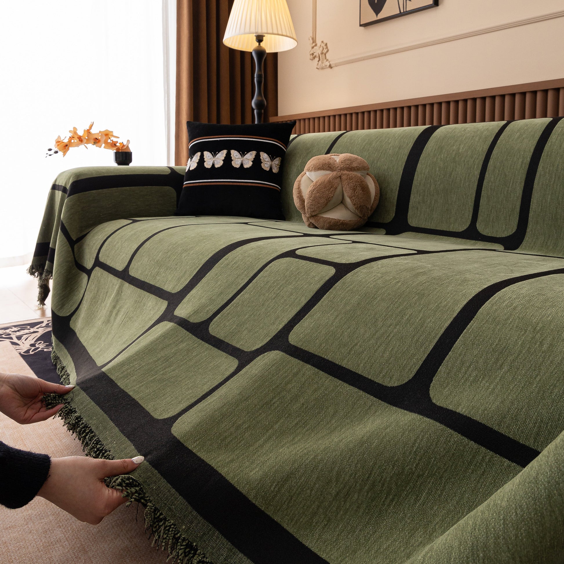 Modern Geometric Sofa Cover Decorative Couch Throw Blanket Furniture Protector with tassels and geometric design on a sofa.
