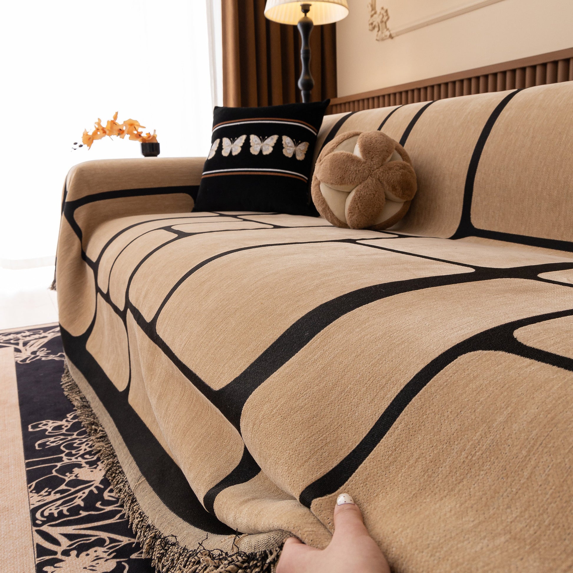 Modern Geometric Sofa Cover Decorative Couch Throw Blanket Furniture Protector with chenille fabric and tassel edges on a couch.