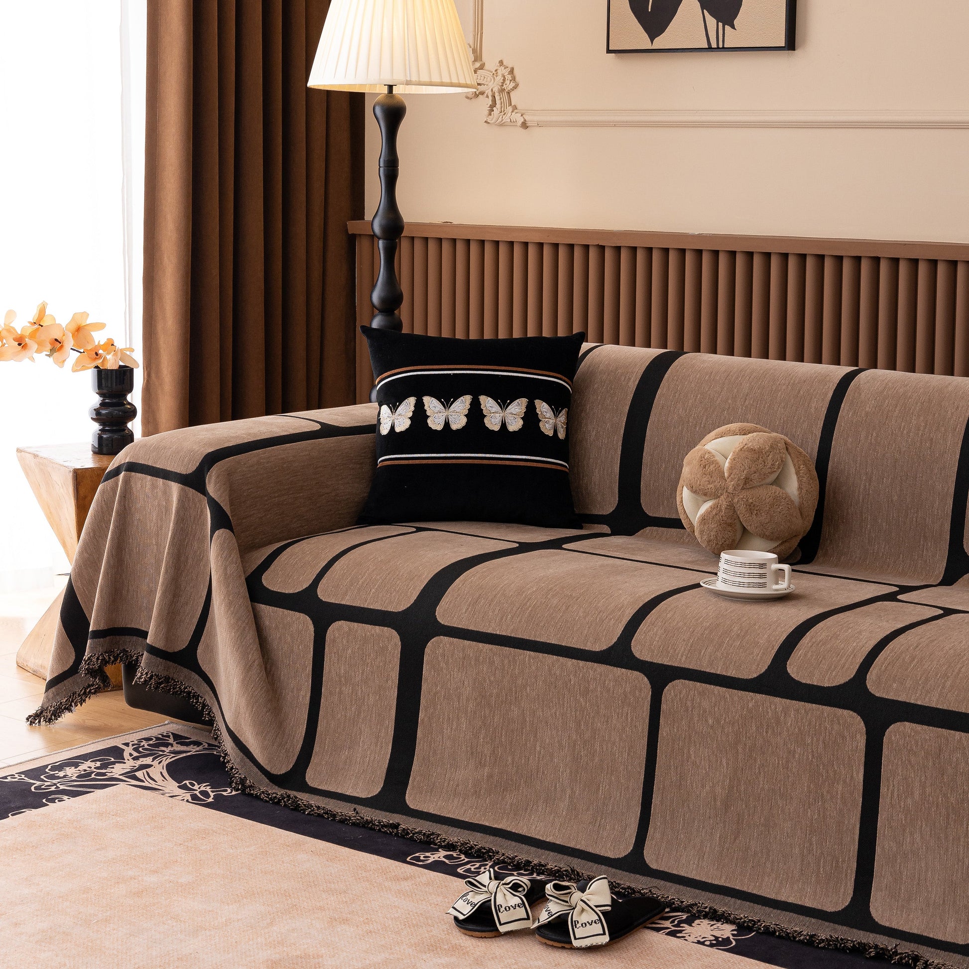 Modern Geometric Sofa Cover Decorative Couch Throw Blanket Furniture Protector with tassel edges on a sofa in a living room setting