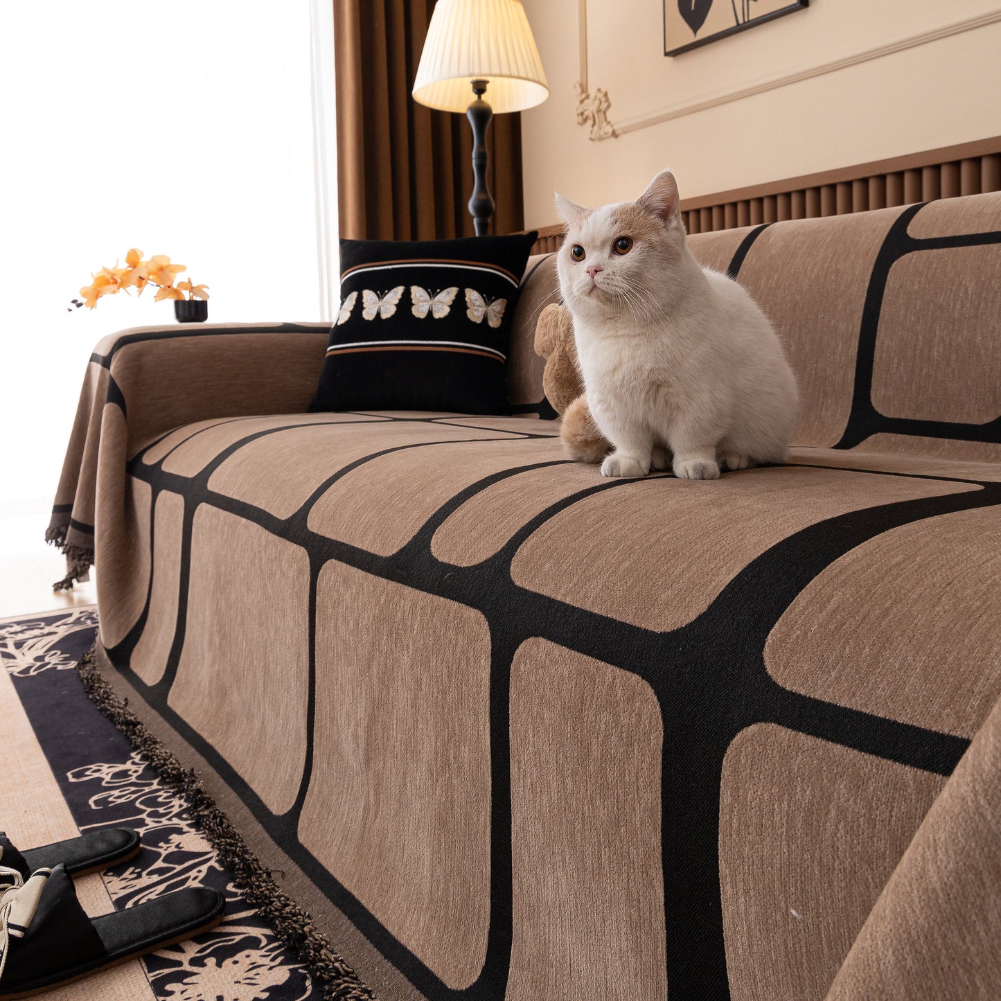 Cat sitting on Modern Geometric Sofa Cover Decorative Couch Throw Blanket Furniture Protector in living room setting.