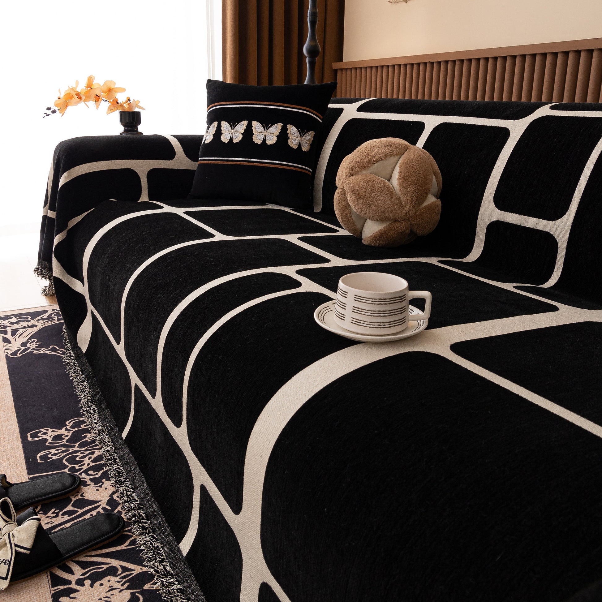 Modern Geometric Sofa Cover Decorative Couch Throw Blanket Furniture Protector with tassel edges and geometric pattern on couch.