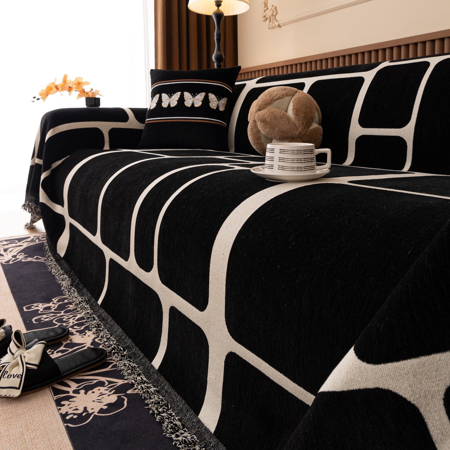Modern Geometric Sofa Cover Decorative Couch Throw Blanket Furniture Protector with black and white pattern on a sofa.