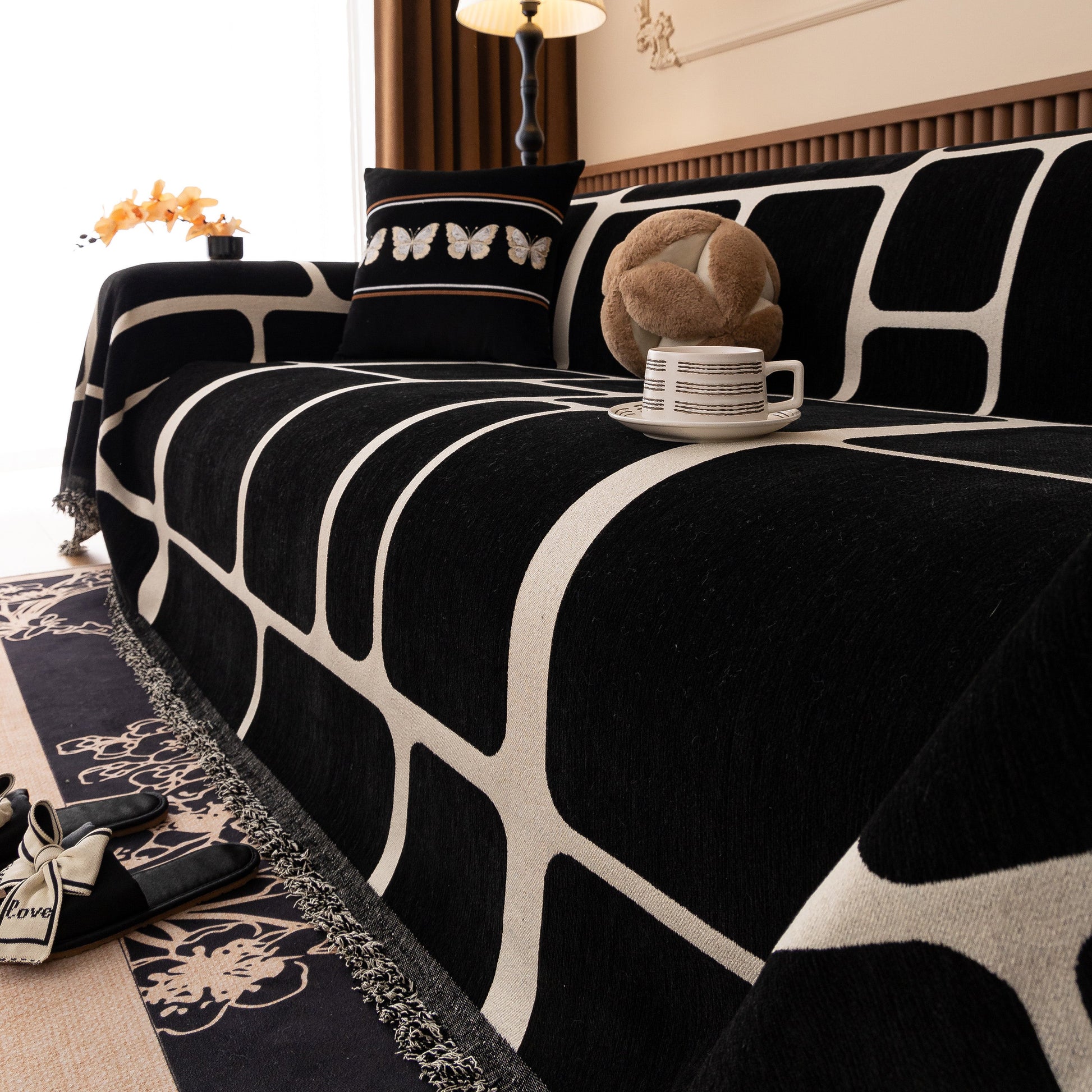 Modern Geometric Sofa Cover Decorative Couch Throw Blanket Furniture Protector with black and white pattern on a sofa.
