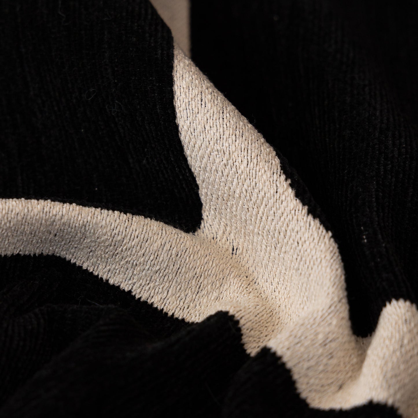 Close-up of a Modern Geometric Sofa Cover Decorative Couch Throw Blanket Furniture Protector with black and white chenille texture.