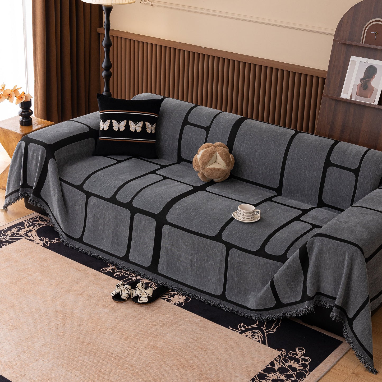 Modern Geometric Sofa Cover Decorative Couch Throw Blanket Furniture Protector with tassel edges on a sofa in a living room setting.
