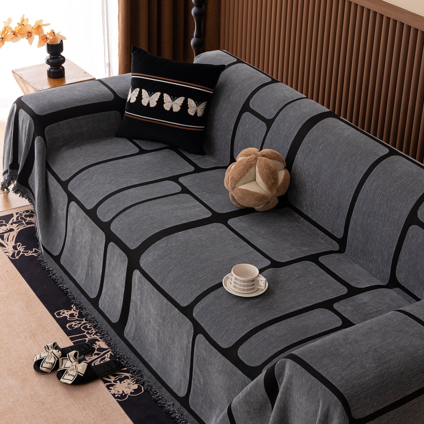 Modern Geometric Sofa Cover Decorative Couch Throw Blanket Furniture Protector on a couch with geometric pattern and tassels
