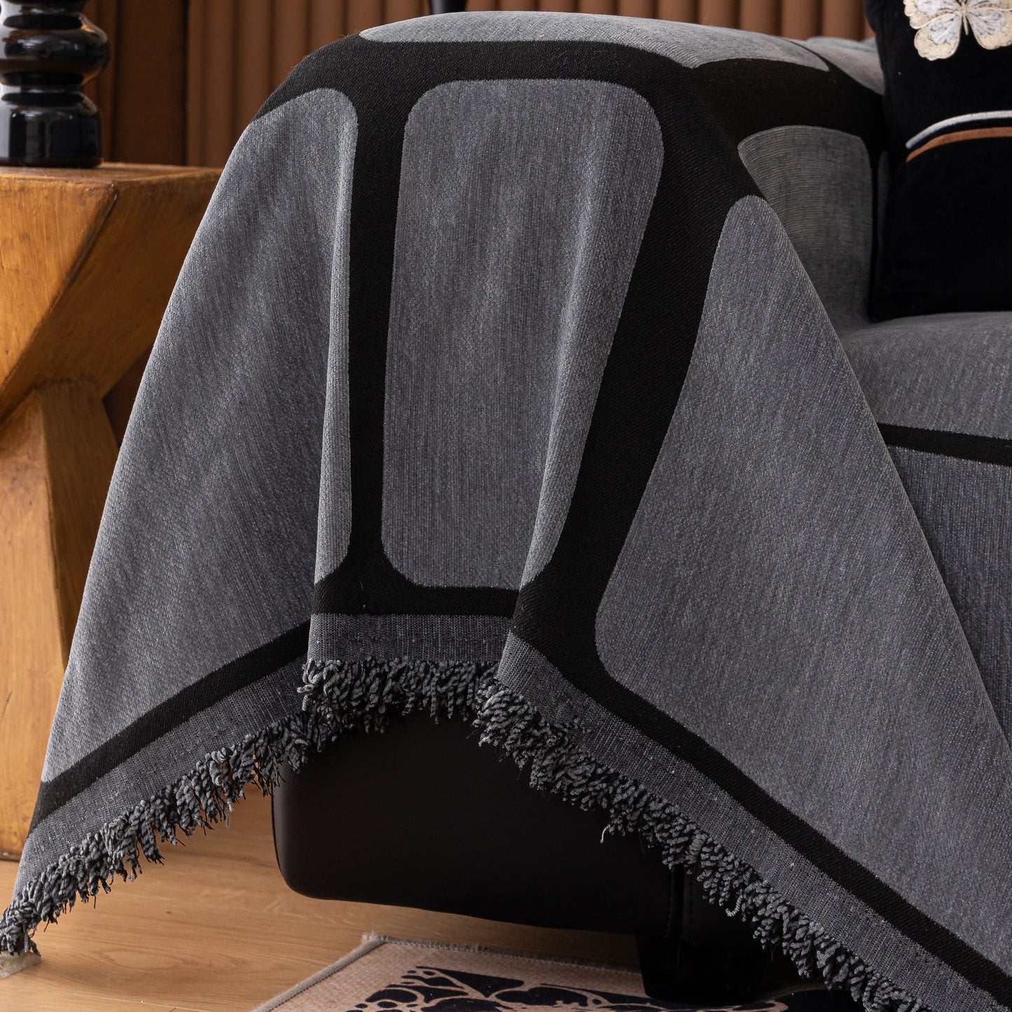 Modern Geometric Sofa Cover Decorative Couch Throw Blanket Furniture Protector in gray with black geometric pattern and tassel edges.