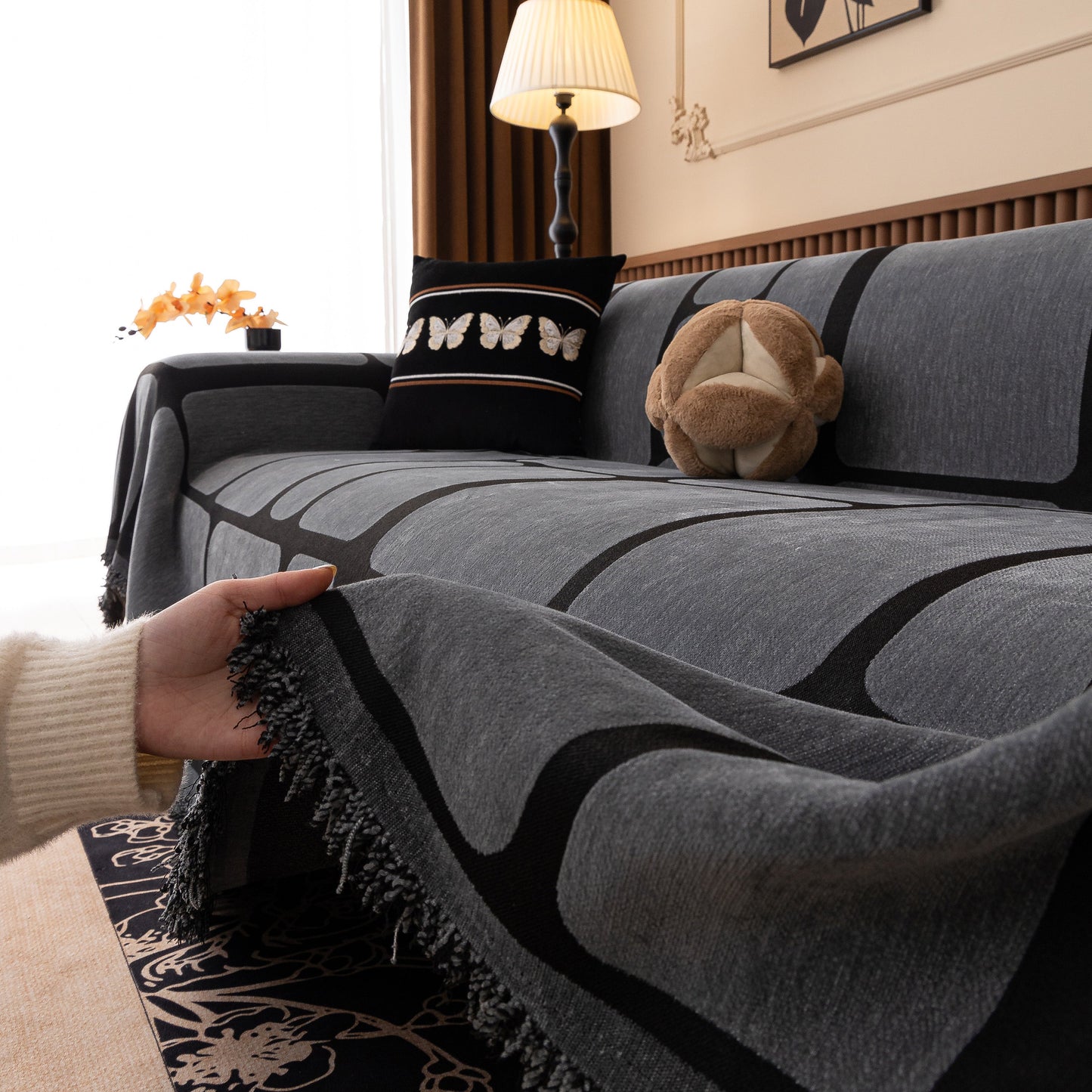 Modern Geometric Sofa Cover Decorative Couch Throw Blanket Furniture Protector with geometric pattern and tassel edges on a couch