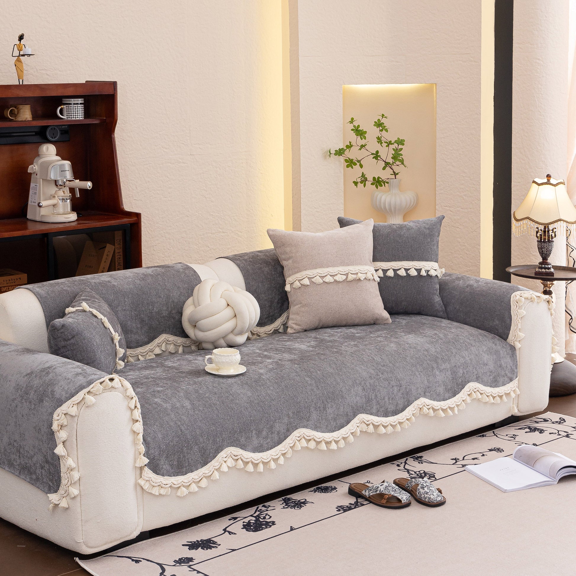 Chenille Sofa Cover Towel – Non-Slip, Washable Pets Couch Protector with Tassels elegantly drapes over a plush, cozy sofa.