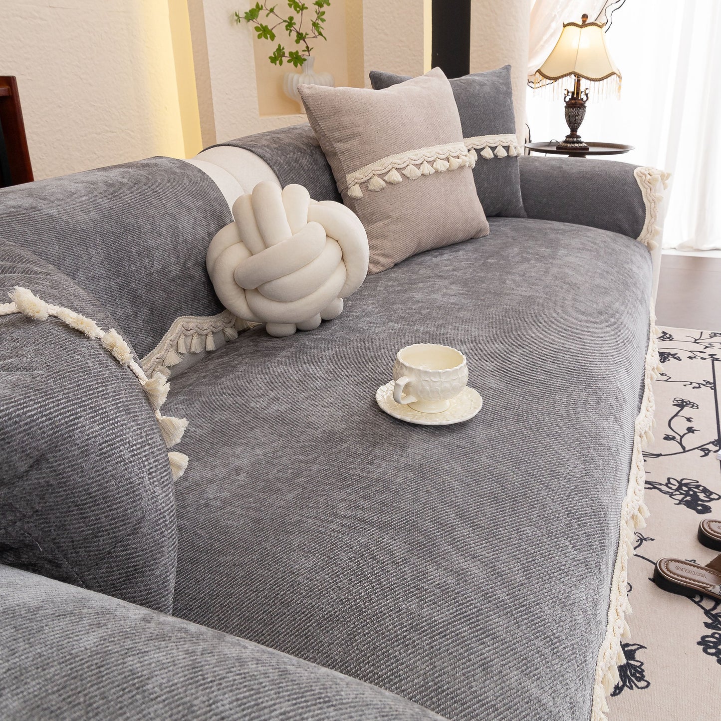 Chenille Sofa Cover Towel – Non-Slip, Washable Pets Couch Protector with Tassels on a grey couch