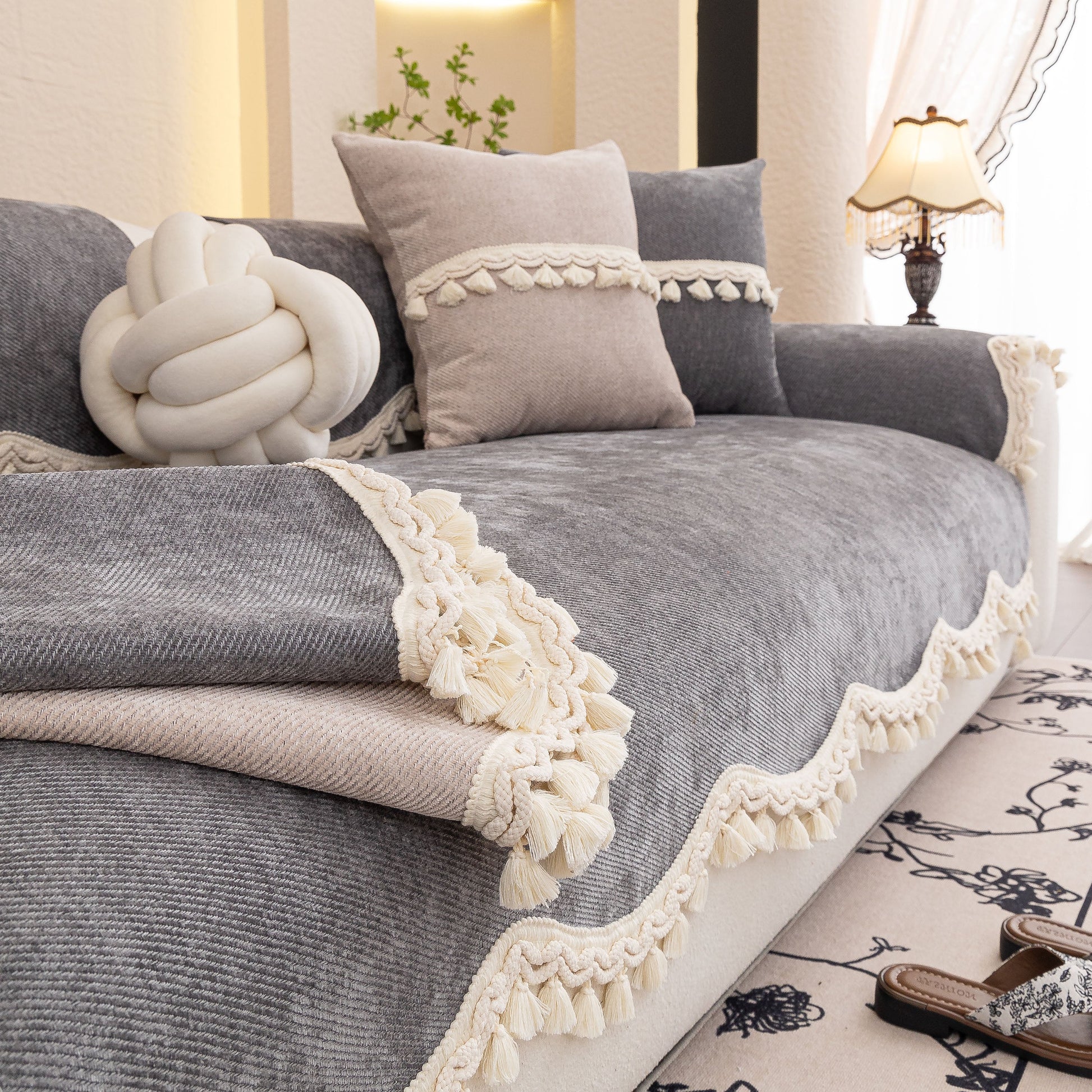Chenille Sofa Cover Towel – Non-Slip, Washable Pets Couch Protector with Tassels on a couch with elegant decor.