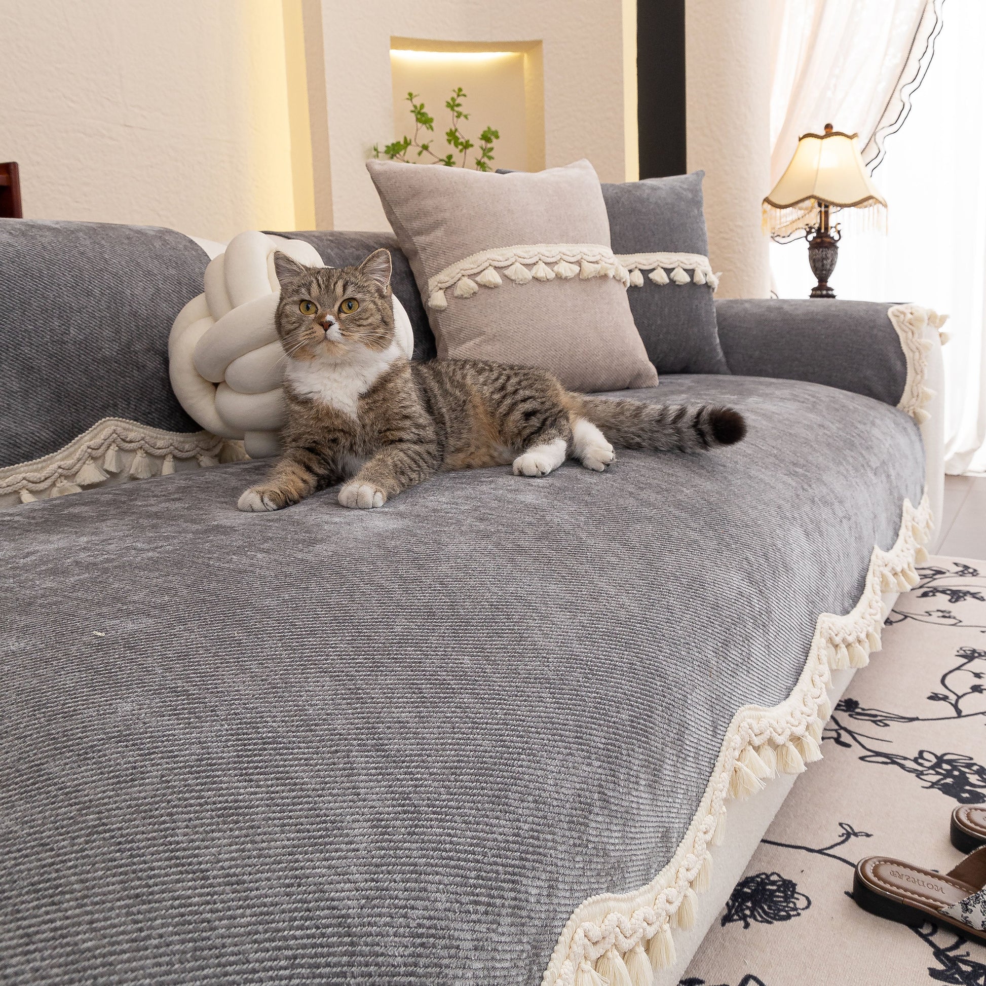 Chenille Sofa Cover Towel – Non-Slip, Washable Pets Couch Protector with Tassels featuring a cat lounging comfortably on it.