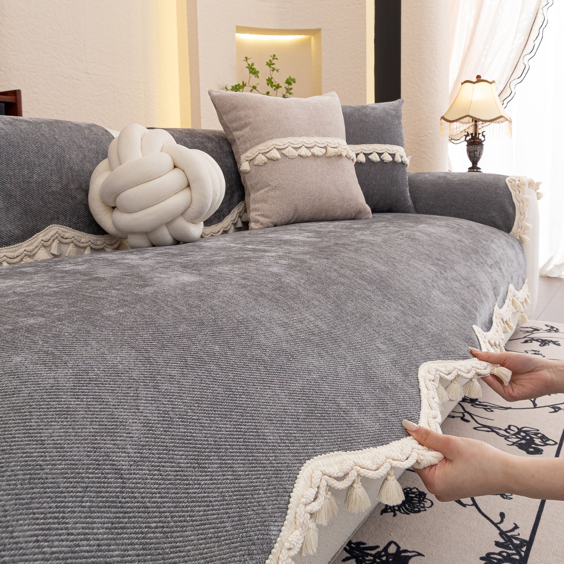 Chenille Sofa Cover Towel – Non-Slip, Washable Pets Couch Protector with Tassels on a couch with decorative pillows, tassel trim.