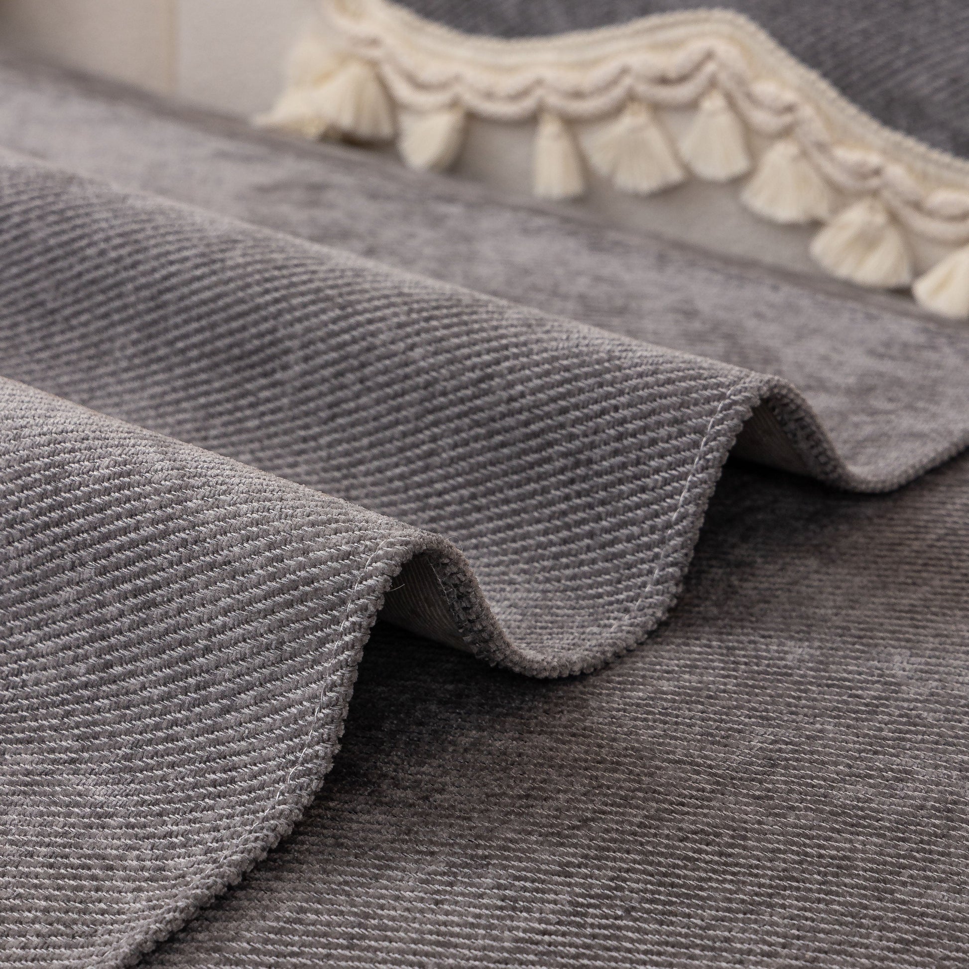 Chenille Sofa Cover Towel – Non-Slip, Washable Pets Couch Protector with Tassels showcasing soft fabric and ivory braided trim.
