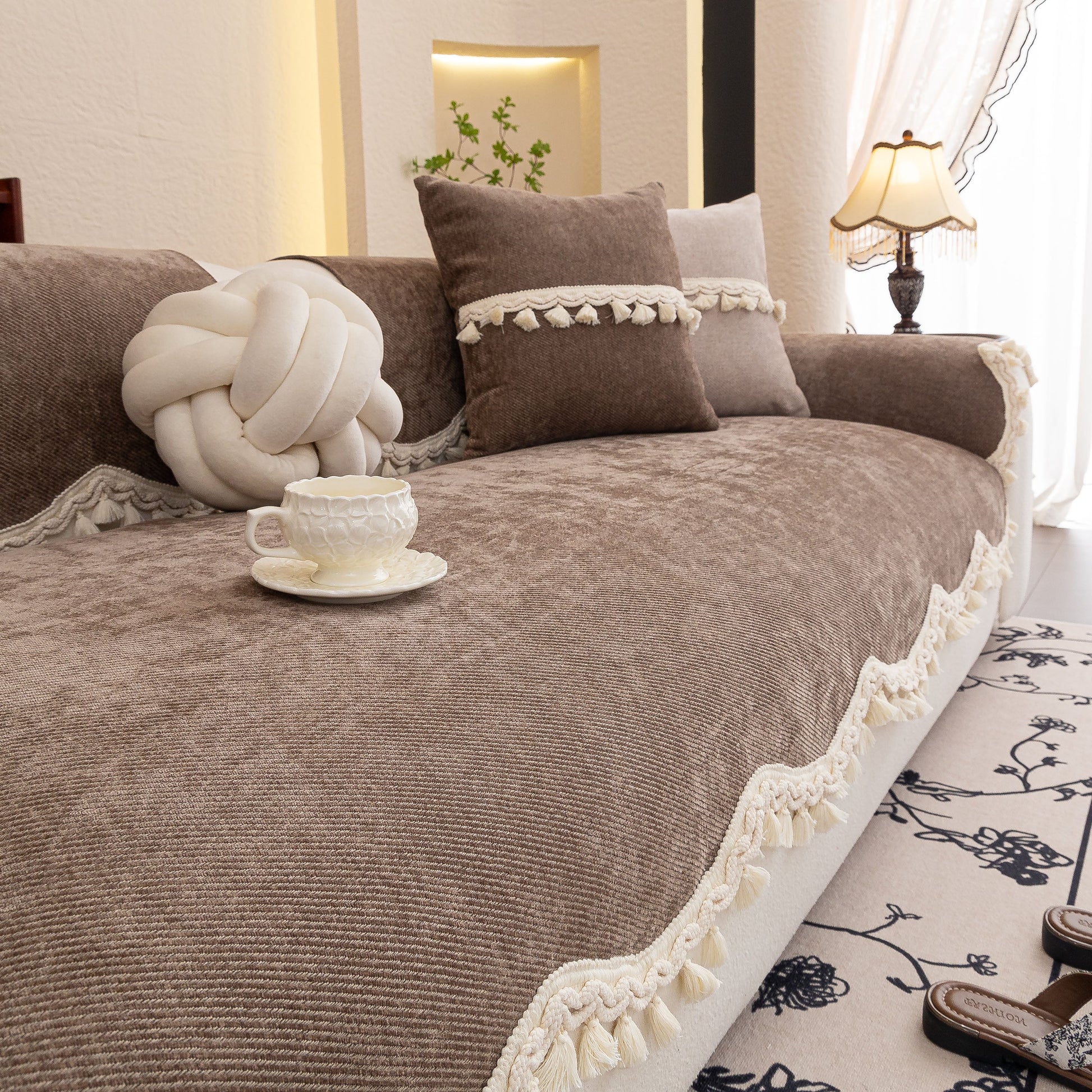 Chenille Sofa Cover Towel – Non-Slip, Washable Pets Couch Protector with Tassels on a couch in a stylish living room.
