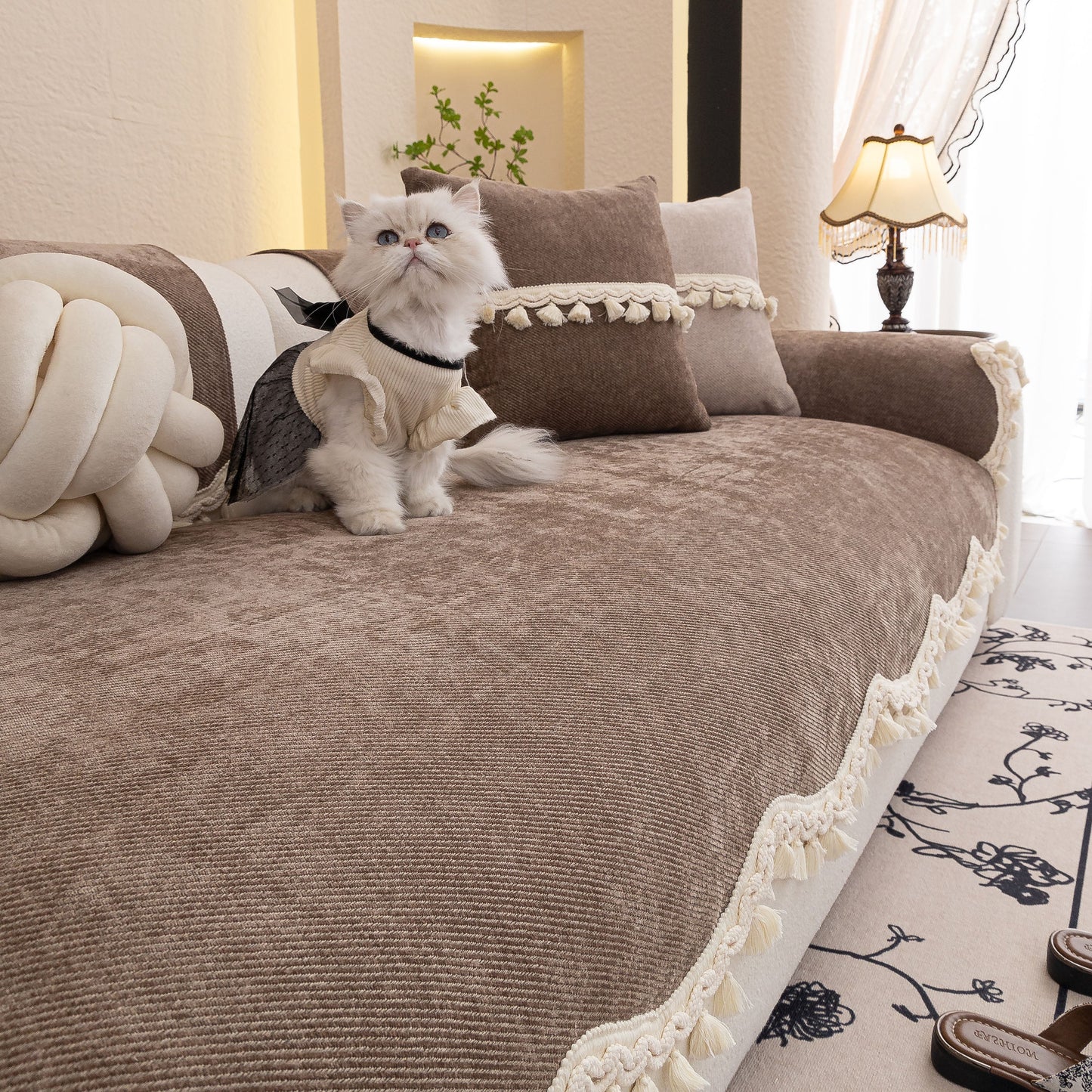Chenille Sofa Cover Towel – Non-Slip, Washable Pets Couch Protector with Tassels on a sofa with a cat and pillows