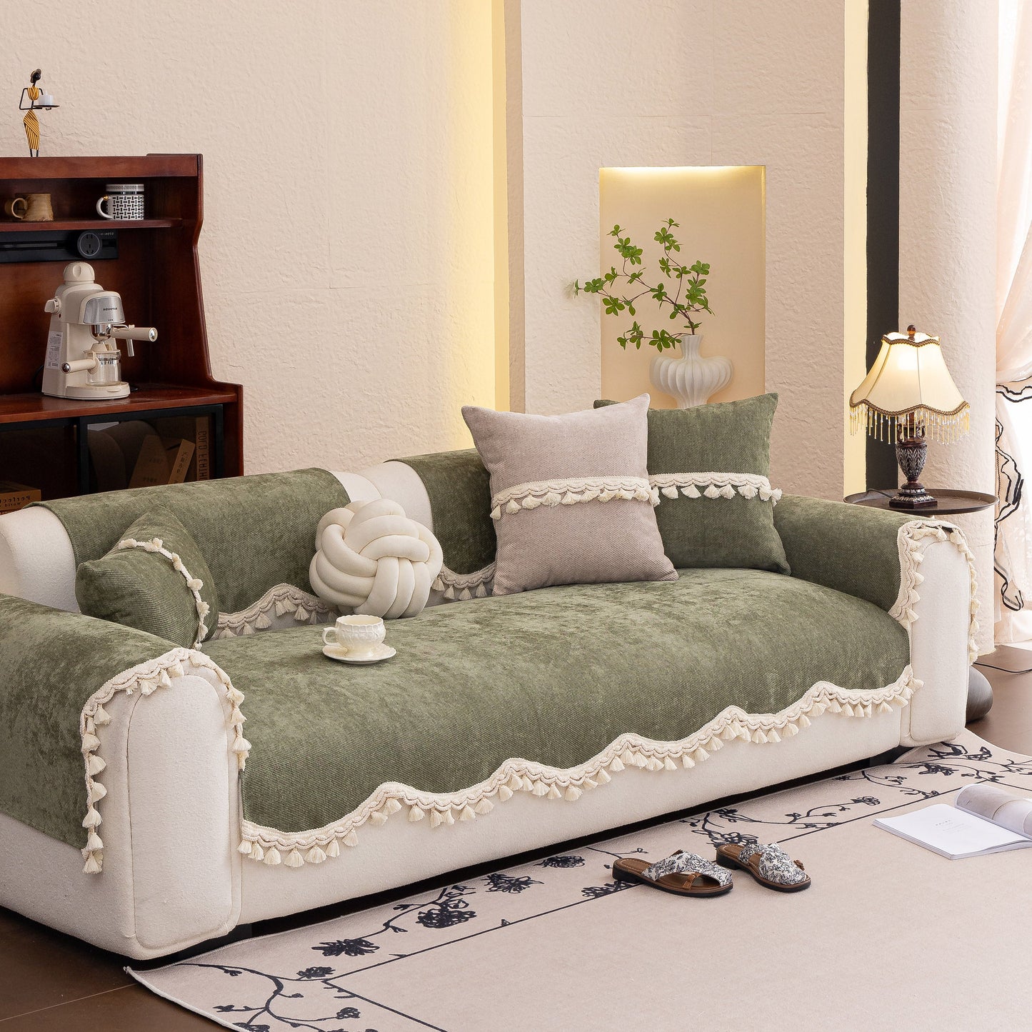 Chenille Sofa Cover Towel – Non-Slip, Washable Pets Couch Protector with Tassels on elegant green sofa with decorative pillows.