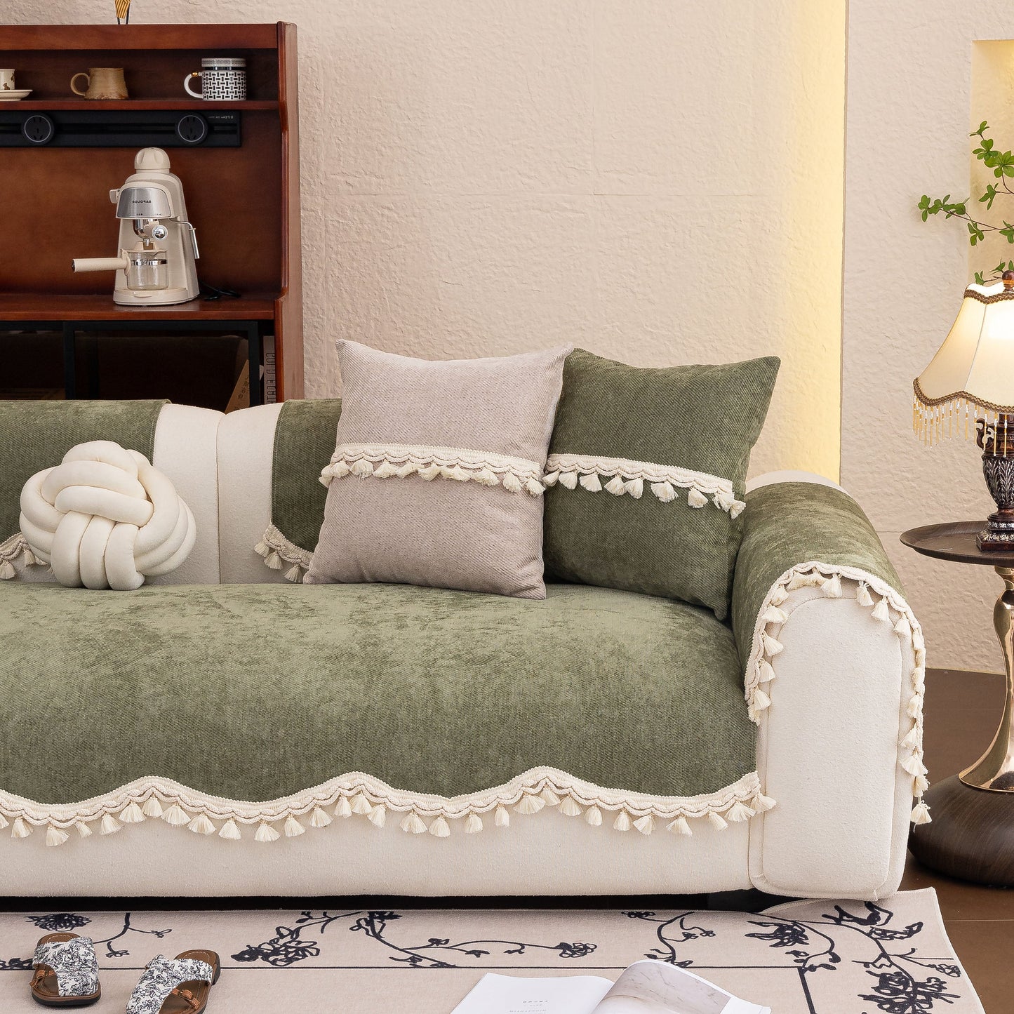 Soft green Chenille Sofa Cover Towel – Non-Slip, Washable Pets Couch Protector with Tassels on beige sofa.