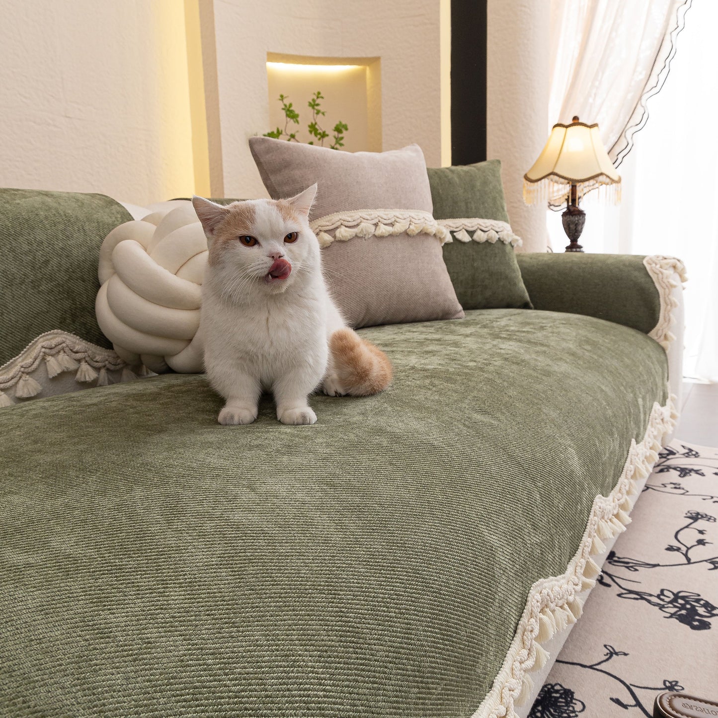 Chenille Sofa Cover Towel – Non-Slip, Washable Pets Couch Protector with Tassels, featuring ivory braided trim, on couch with cat
