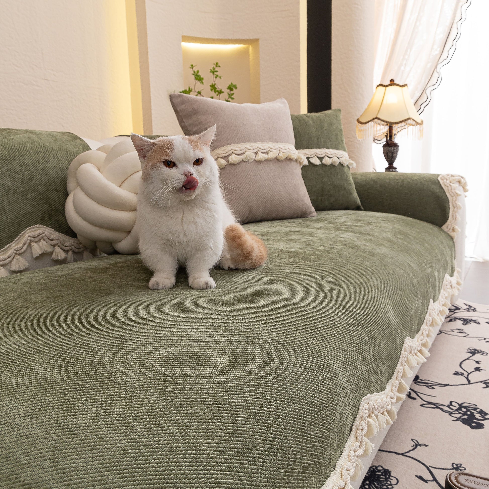 Chenille Sofa Cover Towel – Non-Slip, Washable Pets Couch Protector with Tassels, featuring ivory braided trim, on couch with cat