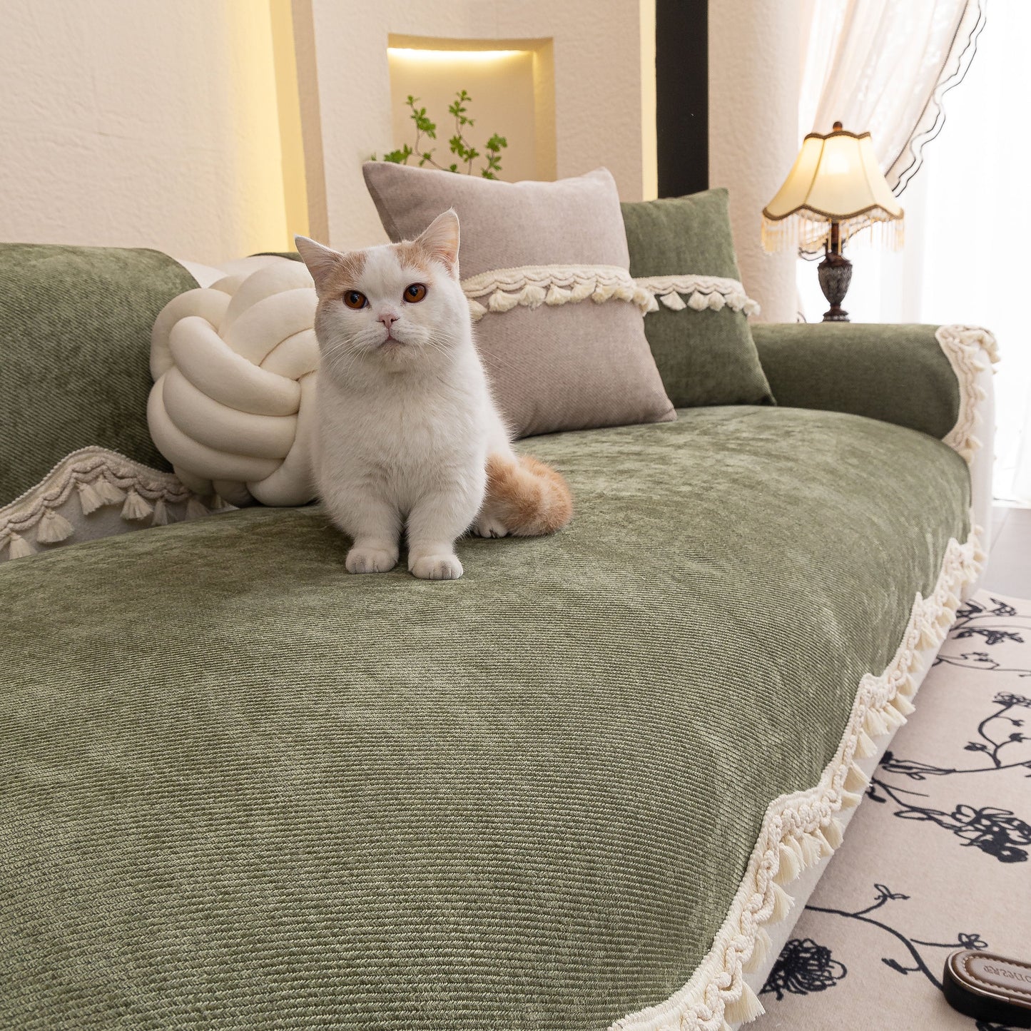 Cat sitting on sofa with Chenille Sofa Cover Towel – Non-Slip, Washable Pets Couch Protector with Tassels in elegant room