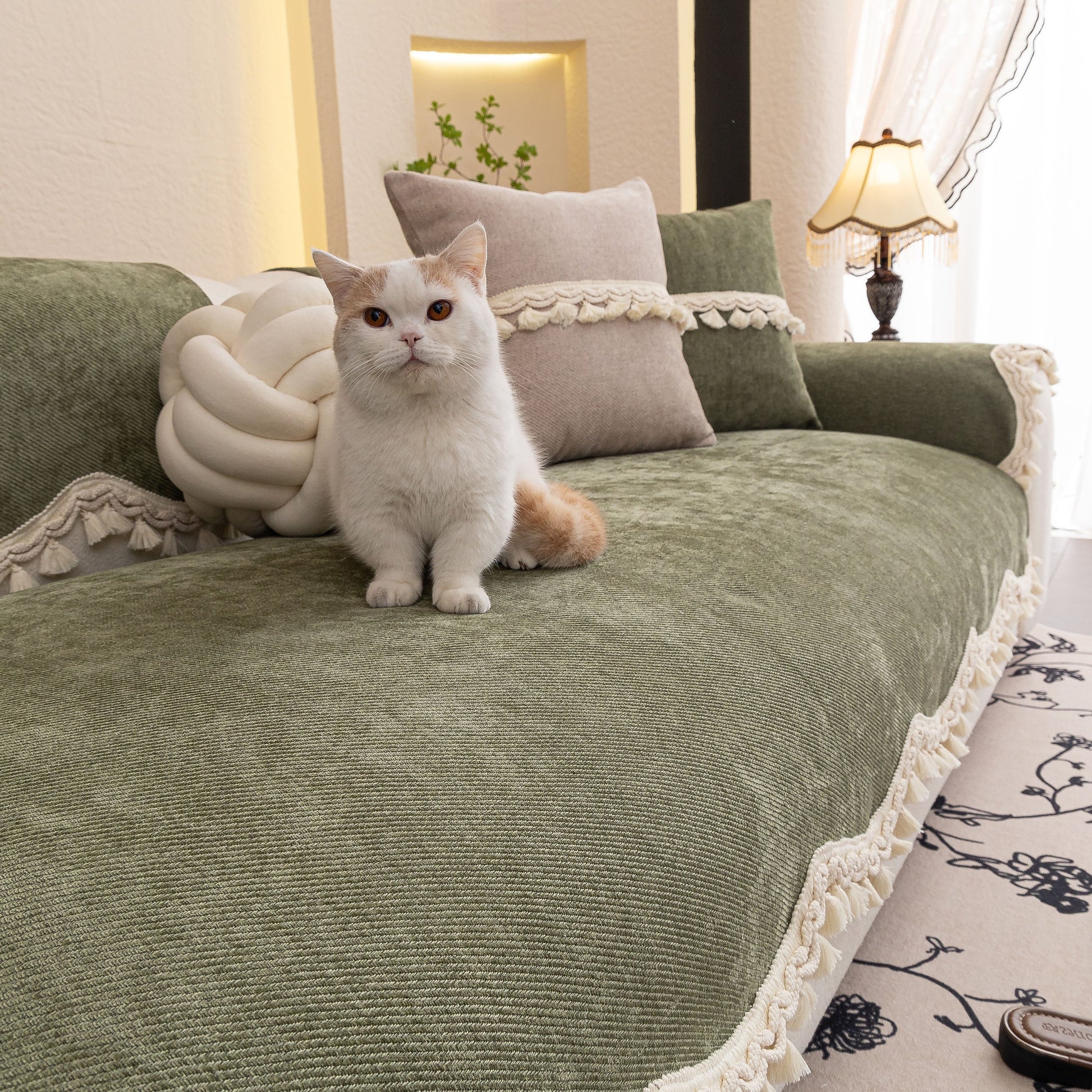 Cat sitting on sofa with Chenille Sofa Cover Towel – Non-Slip, Washable Pets Couch Protector with Tassels in elegant room