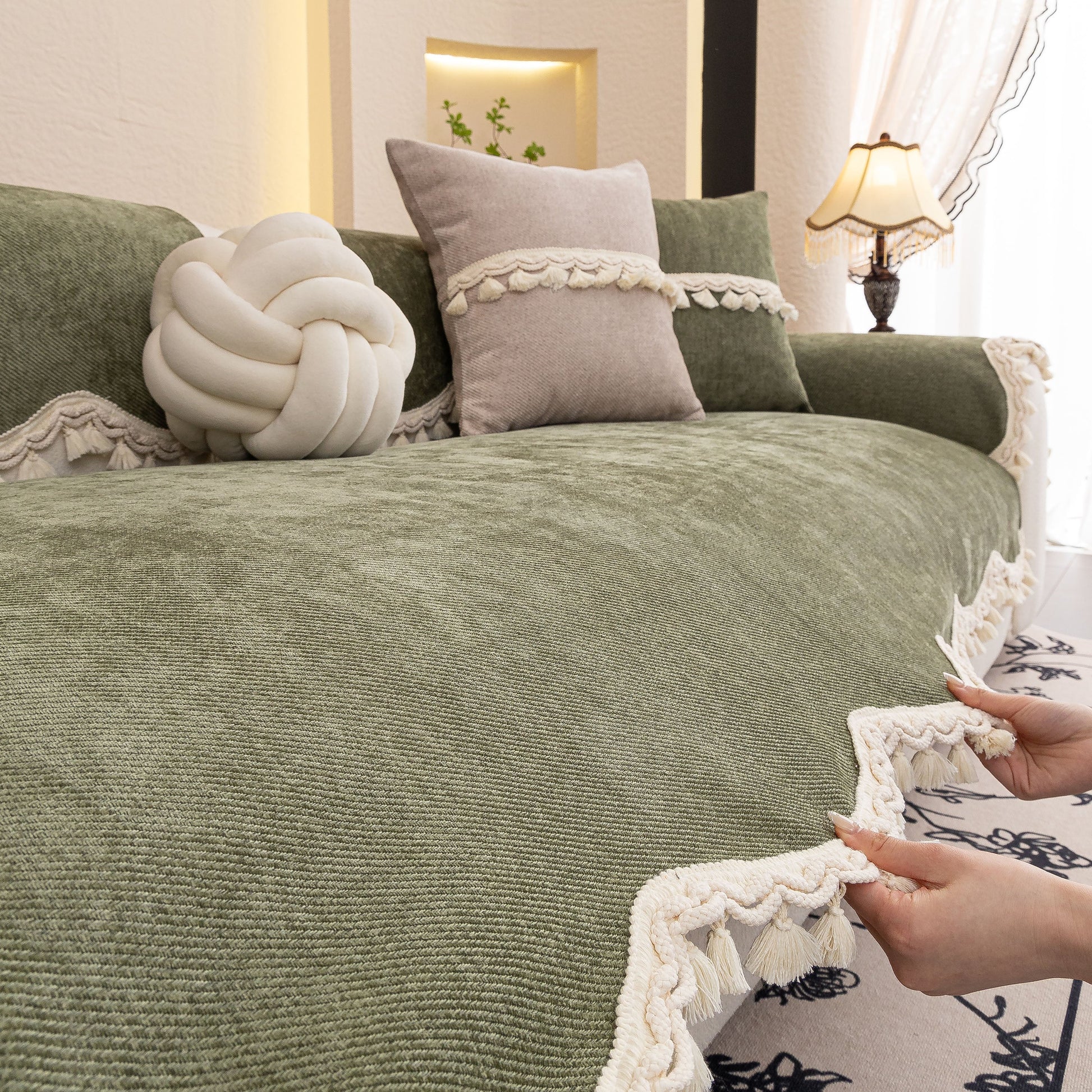 Chenille Sofa Cover Towel – Non-Slip, Washable Pets Couch Protector with Tassels on olive green sofa with decorative pillows.