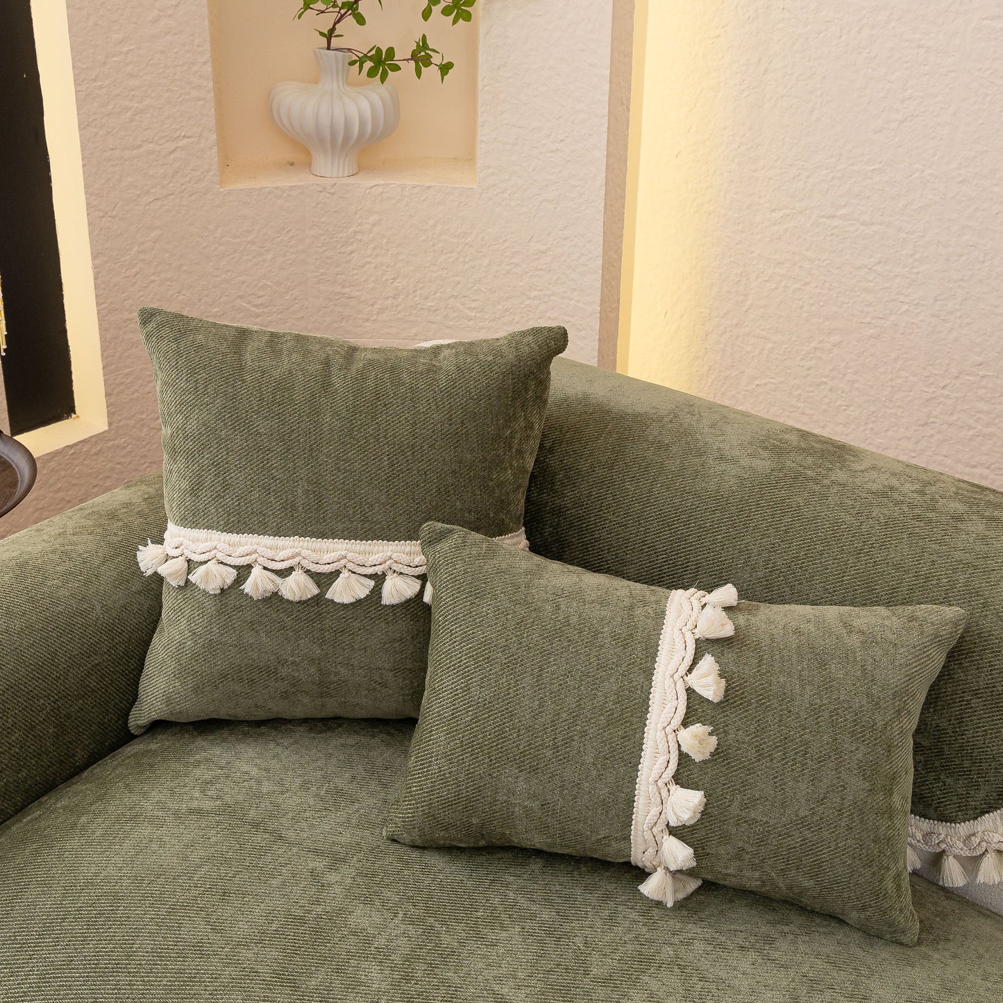 Chenille Sofa Cover Towel – Non-Slip, Washable Pets Couch Protector with Tassels featuring green fabric and ivory braided trim.