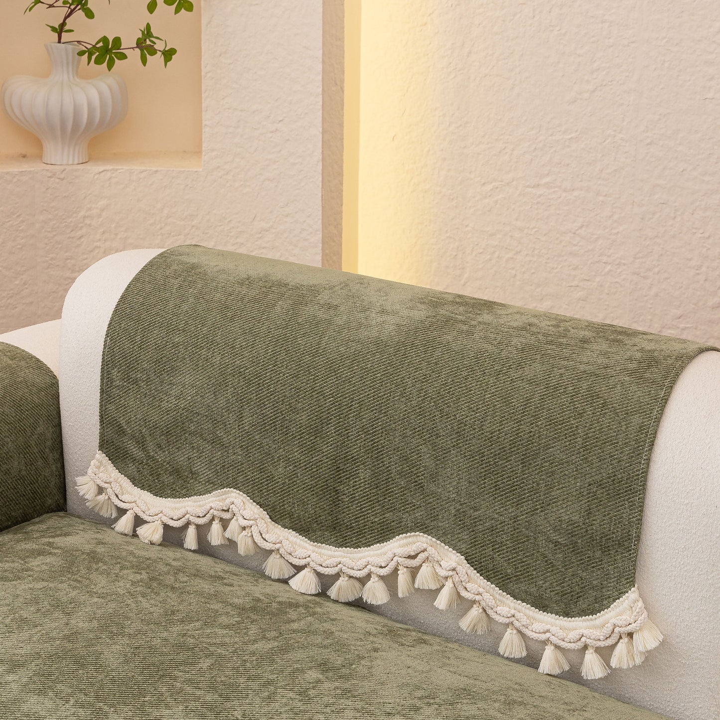 Chenille Sofa Cover Towel – Non-Slip, Washable Pets Couch Protector with Tassels draped on sofa armrest.