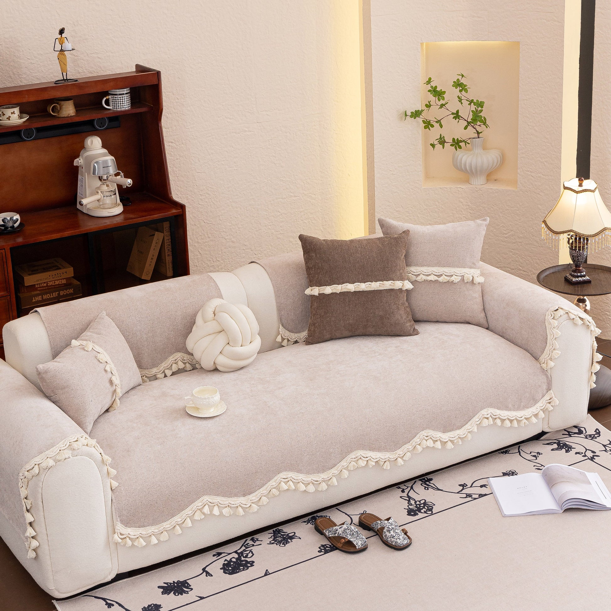Chenille Sofa Cover Towel – Non-Slip, Washable Pets Couch Protector with Tassels on a beige sofa in an elegant living room.