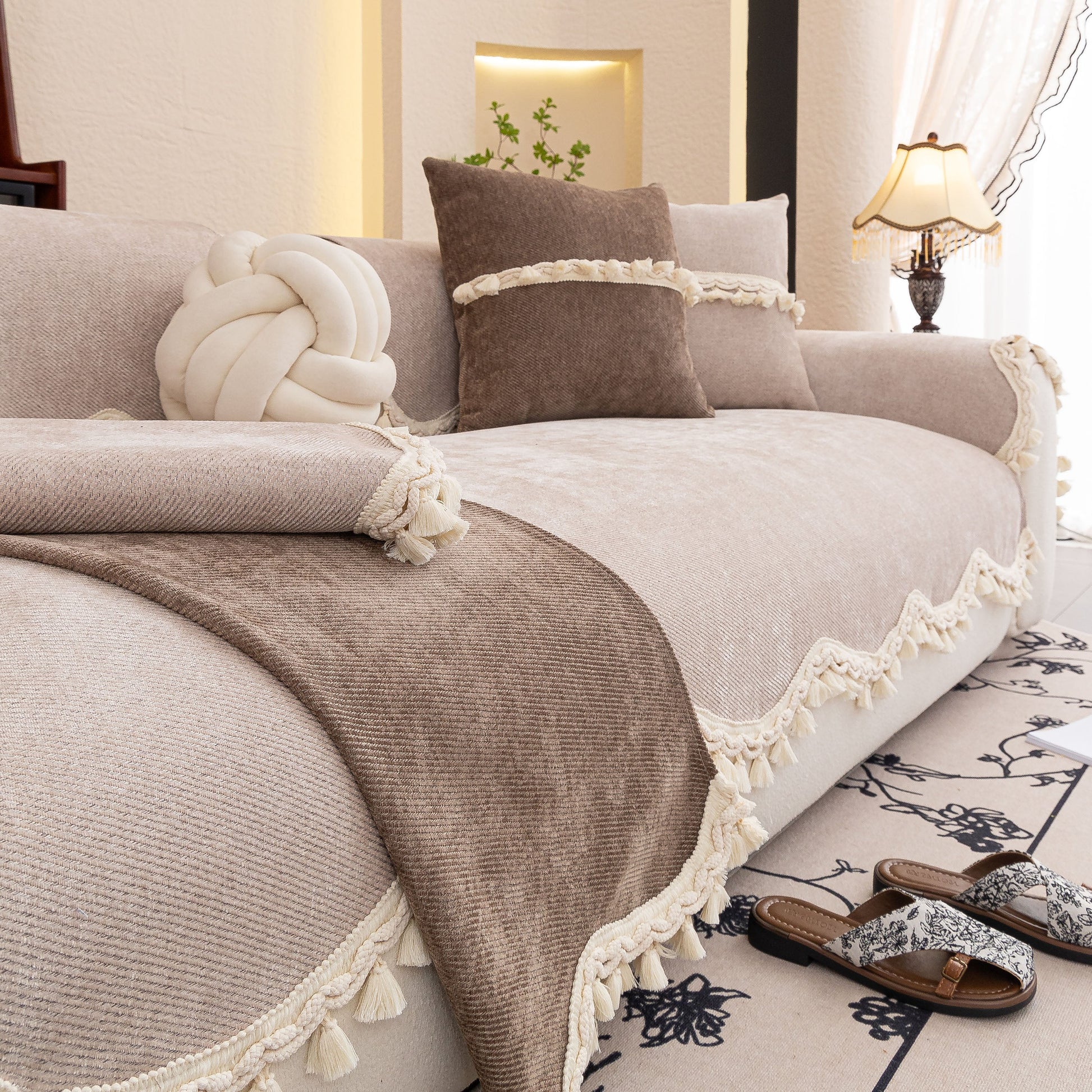 Chenille Sofa Cover Towel – Non-Slip, Washable Pets Couch Protector with Tassels displayed on a sofa in a cozy living room.