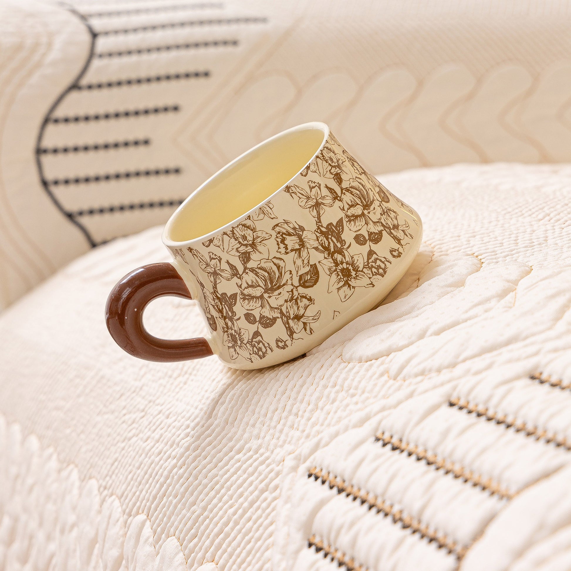 Decorative mug on 3D Quilted Thick Cotton Sofa Cover Non-Slip Couch Throw for Fabric & Leather Sofas with embossed stitching.