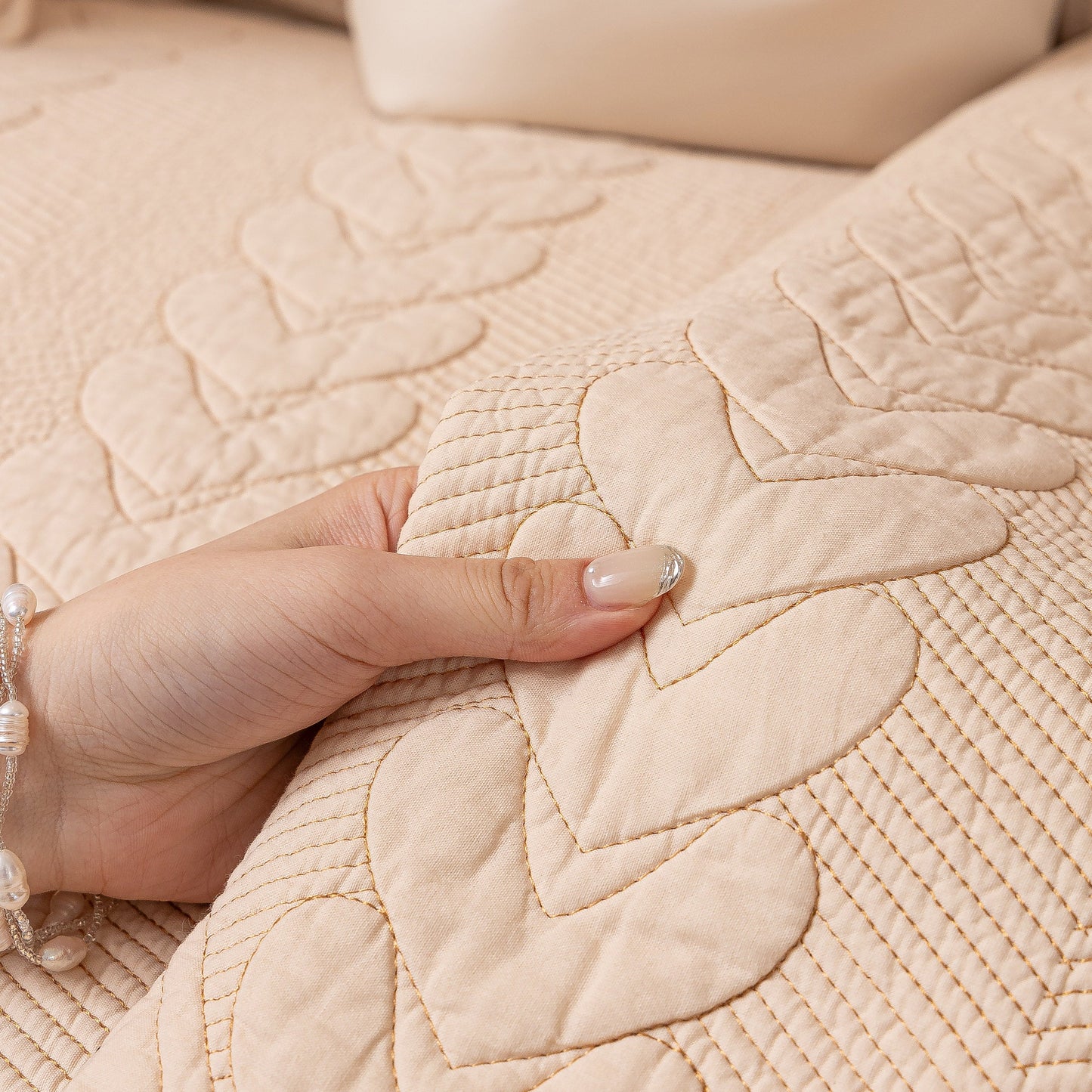 Close-up of 3D Quilted Thick Cotton Sofa Cover Non-Slip Couch Throw for Fabric & Leather Sofas with embossed heart stitching