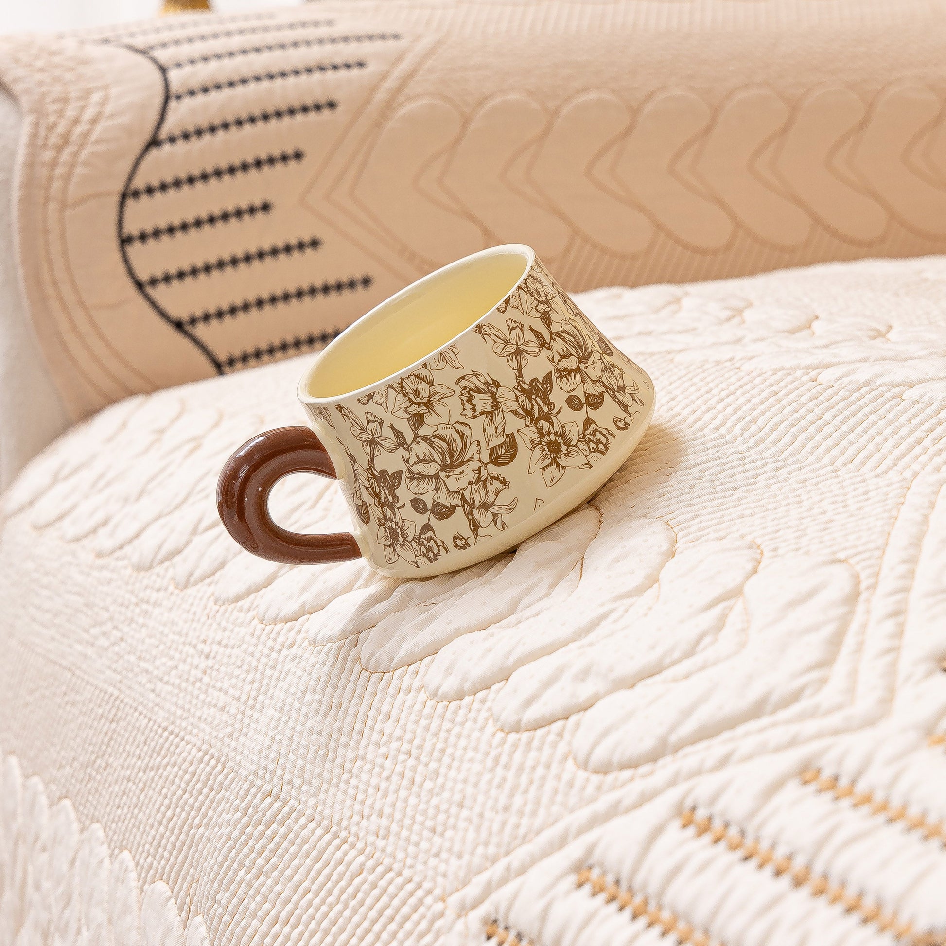 3D Quilted Thick Cotton Sofa Cover Non-Slip Couch Throw for Fabric & Leather Sofas with a cup resting on it