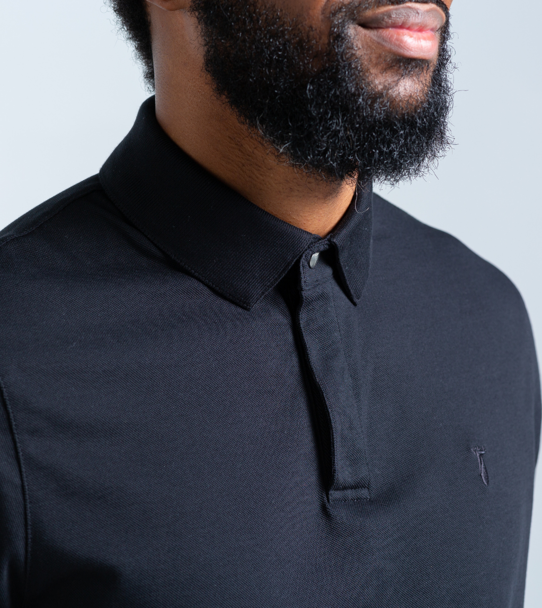 Close-up of man wearing Baobab Short Sleeve Perfect Polo with StaySharp™ Collar, showcasing crisp style and tailored comfort.