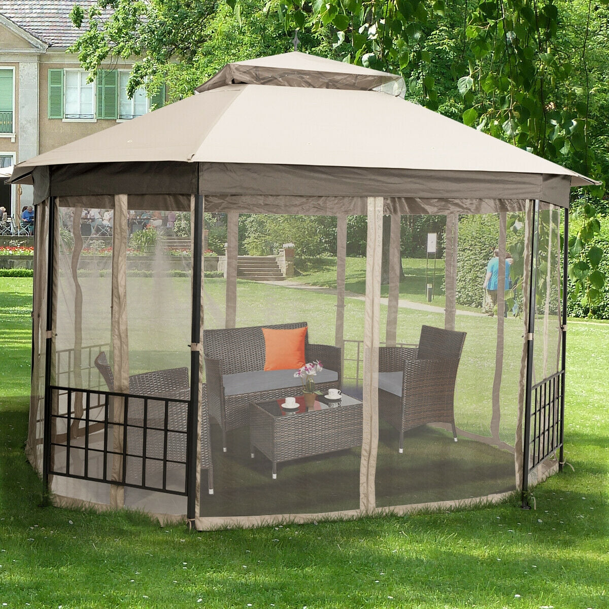 10’x 12’ Octagonal Patio Gazebo-Beige in backyard setting with furniture inside, offering shade and comfort for outdoor gatherings.