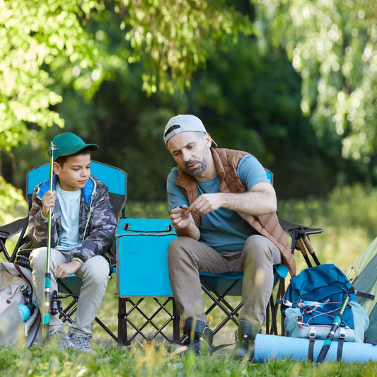 Father and son camping with Portable Folding Camping Canopy Chairs with Cup Holder-Blue in a forest setting.