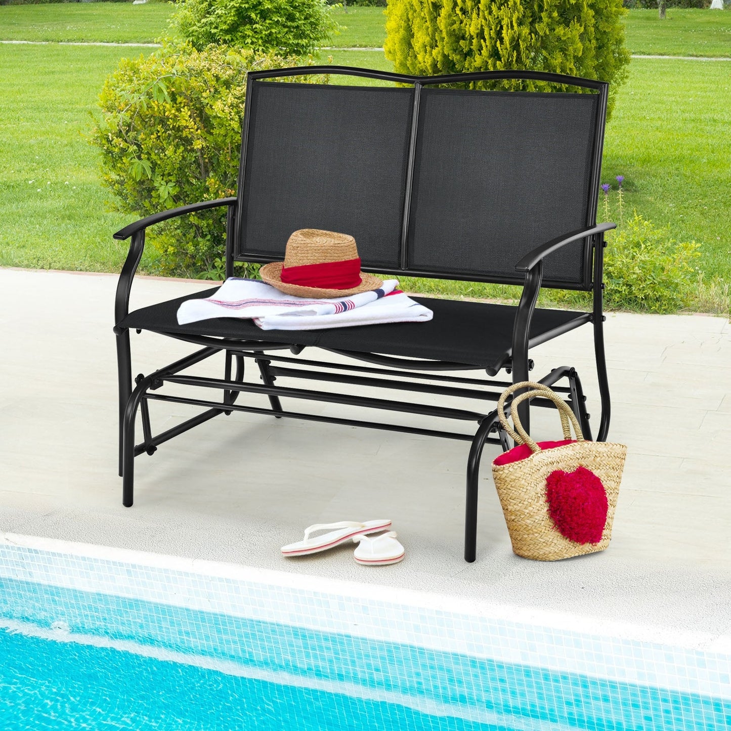 Iron Patio Rocking Chair for Outdoor Backyard and Lawn-Black beside a pool with accessories