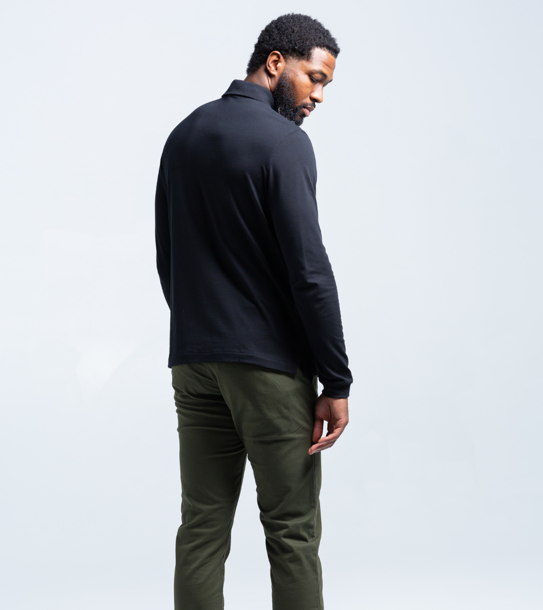Man wearing a Baobab Long Sleeve Perfect Polo with StaySharp™ Collar, hidden microfiber cloth, tailored fit, and cutting-edge innovation.